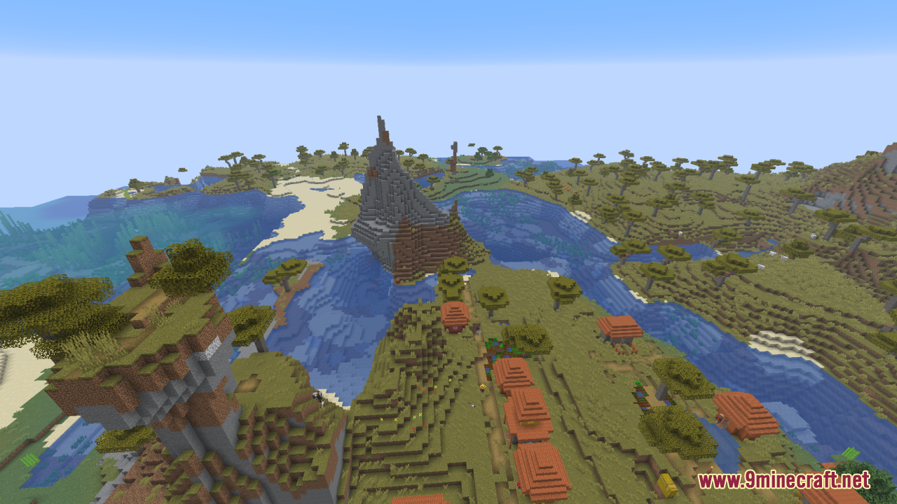 Savanna village next to a lake with a tall stone mountain peak