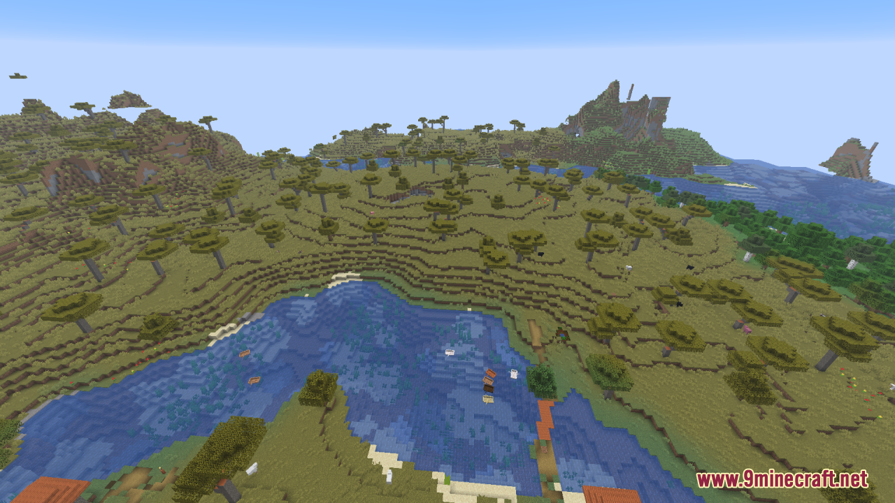 Scenic view of a savanna biome with a lake and rolling hills