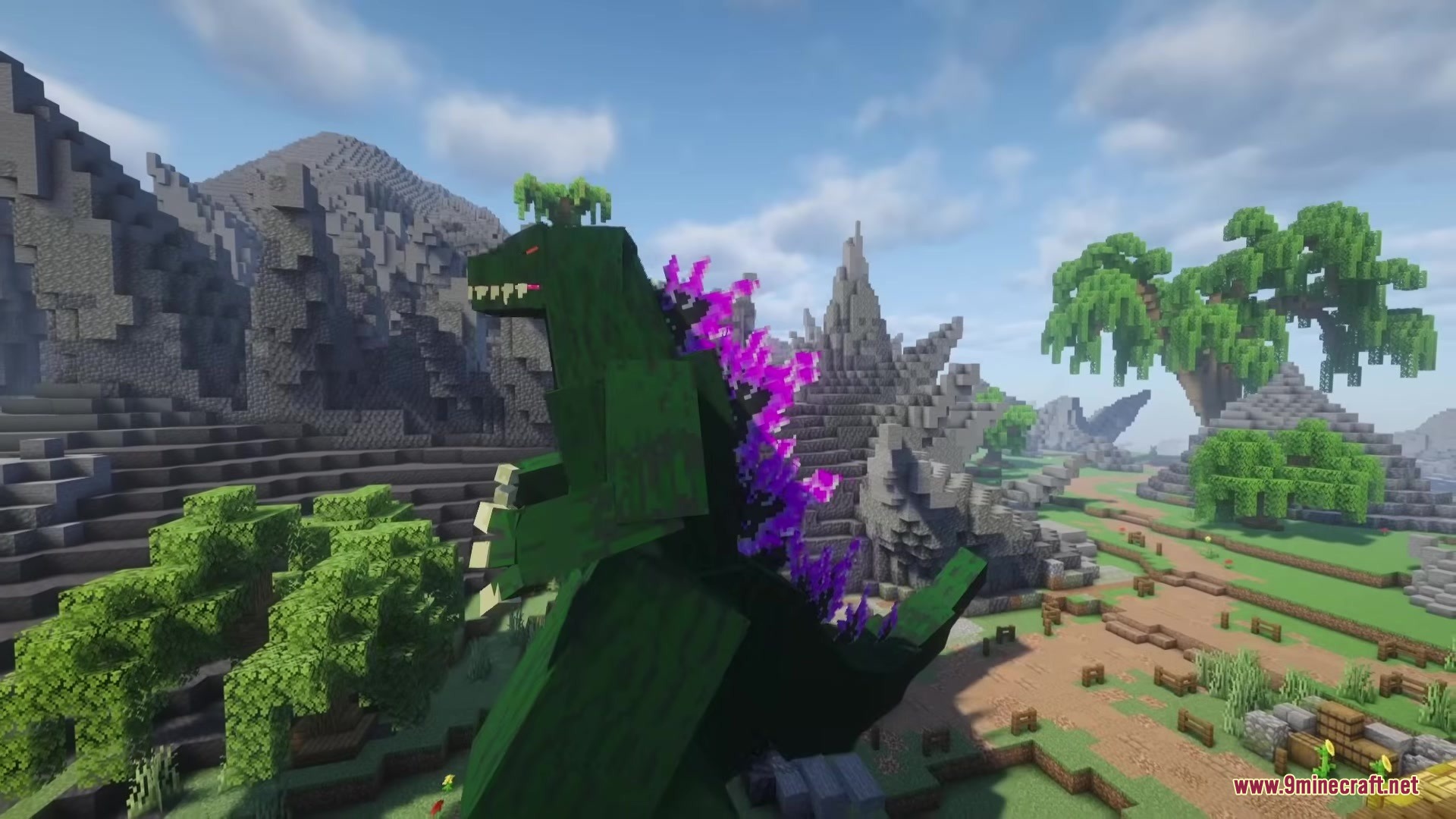 Godzilla Reborn Mod Screenshot 6 Giant green Godzilla with purple glowing fins in a rocky Minecraft landscape