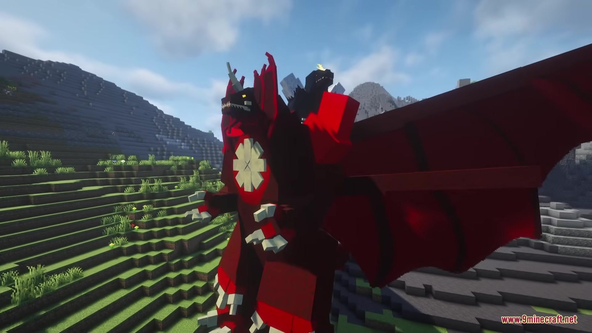 Godzilla Reborn Mod Screenshot 8 The massive red Destoroyah monster stands on a grassy hill in Minecraft