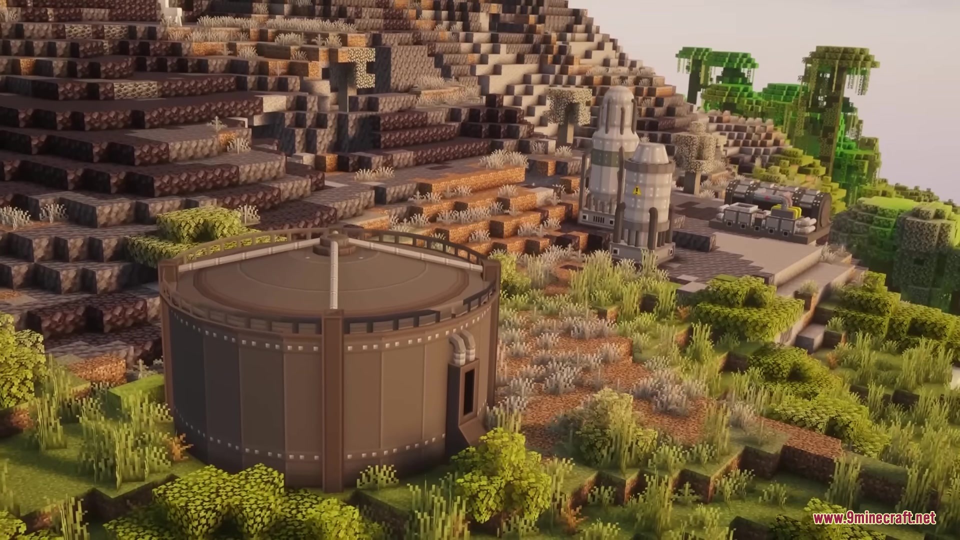 Large industrial storage tanks and silos built on a hillside in Minecraft