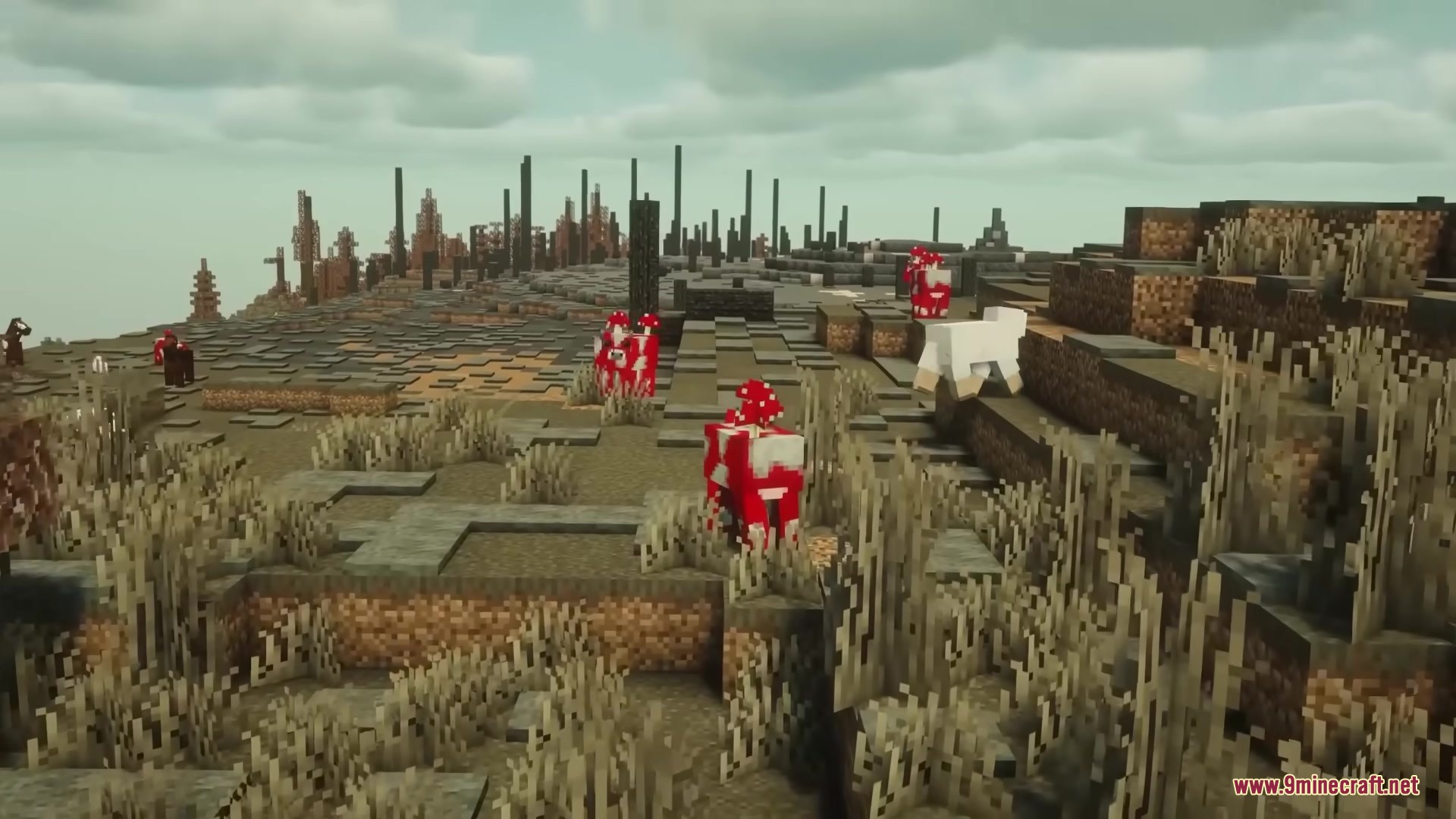 Mooshrooms wandering through a desolate landscape with tall black pillars and dead bushes