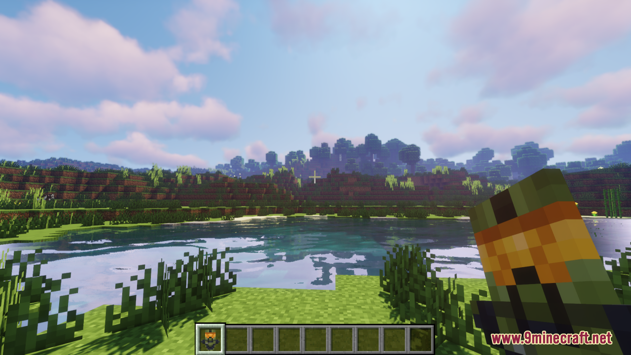 Player holding a Master Chief themed Totem of Undying near a large lake