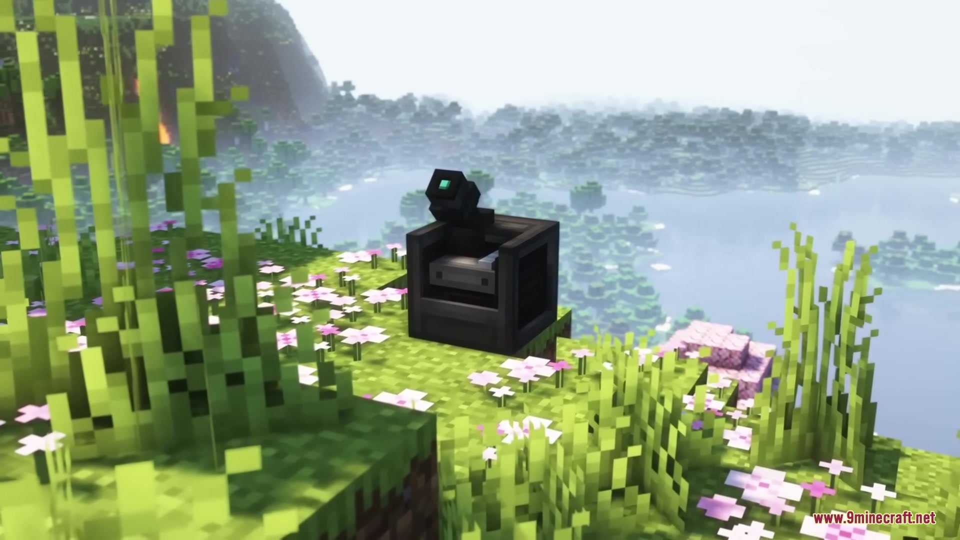 A black medical scanner block placed on a grassy hill overlooking a lake