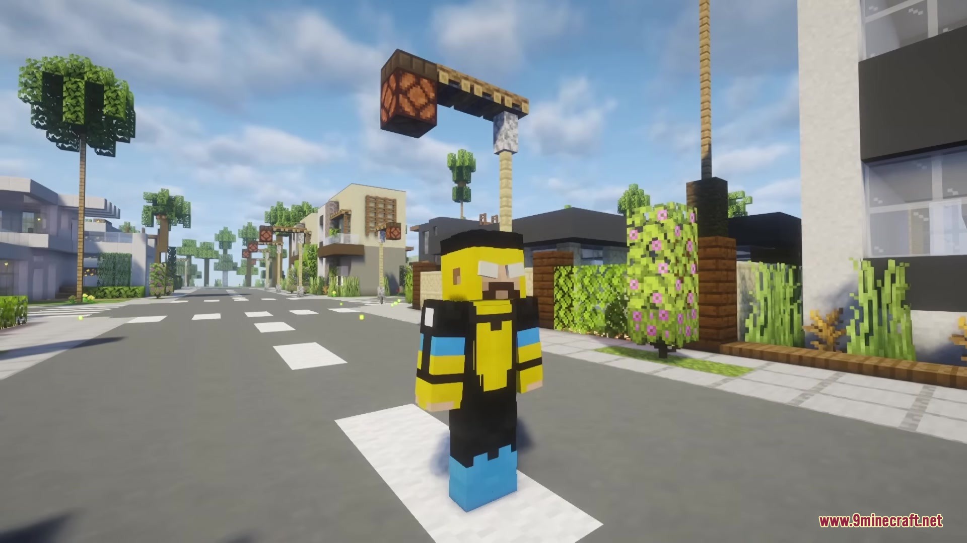 Invincible Incorporated Mod Screenshot 2 The Omni Man character stands on a road in a modern Minecraft neighborhood