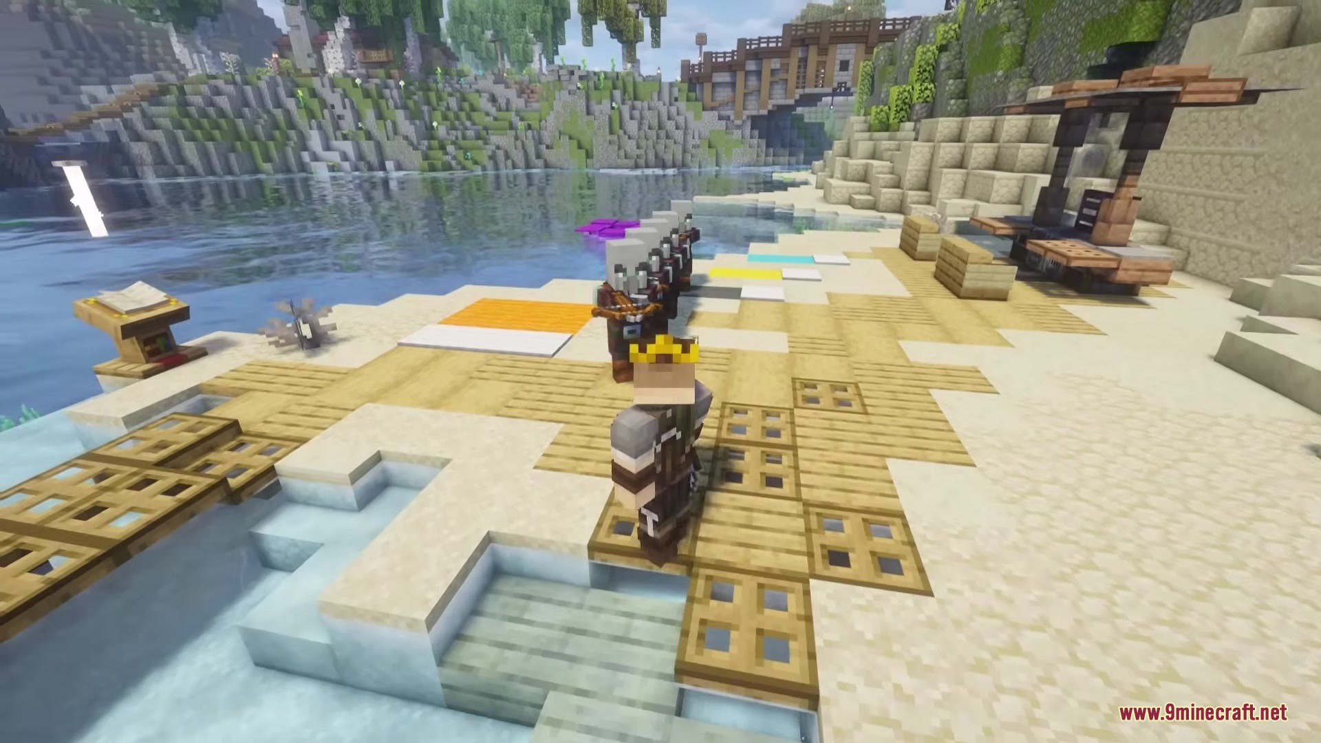 A player wearing a crown looks at armor stands holding crossbows on a beach