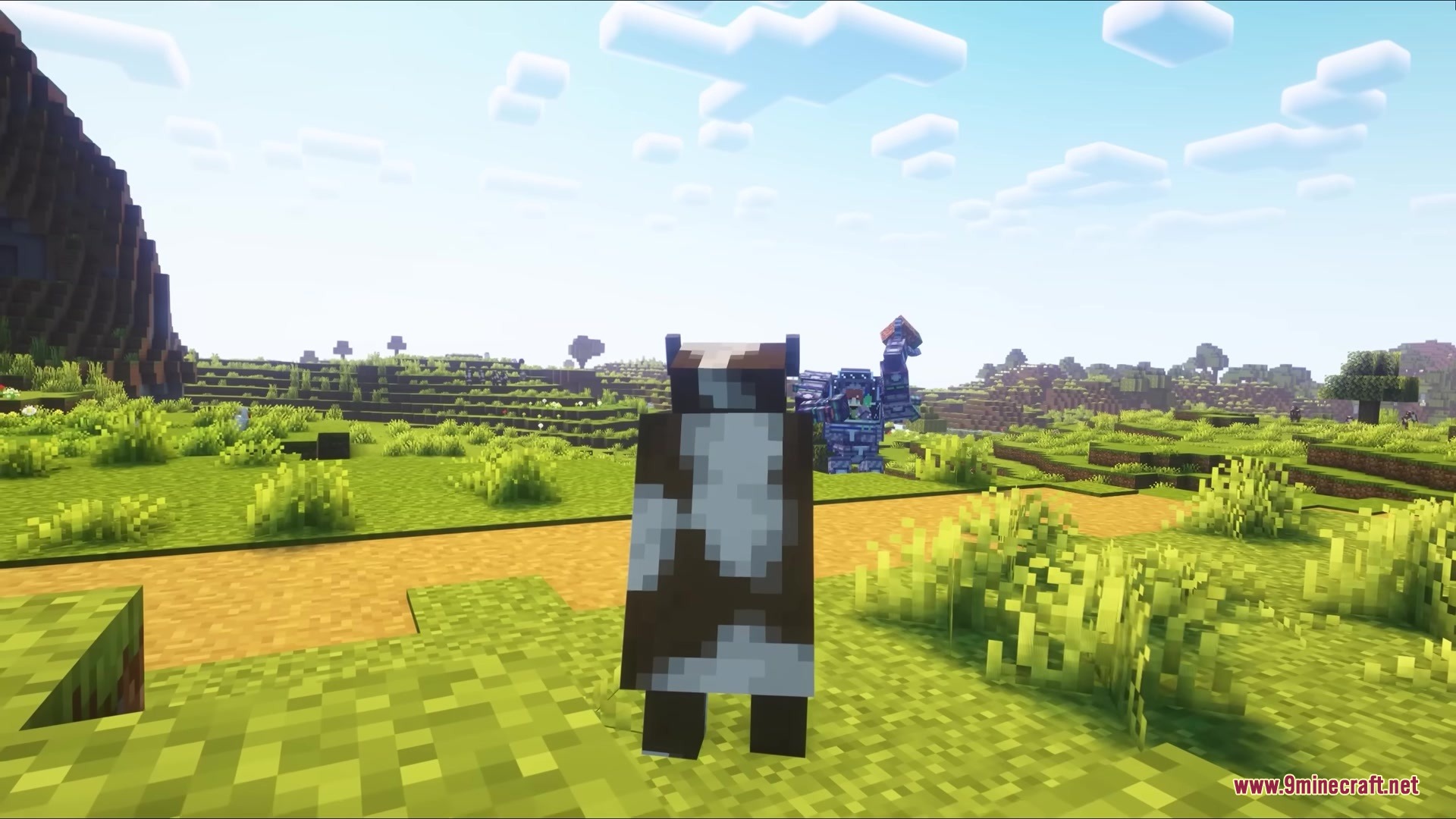 Jim Mech Mod Screenshot 7 A brown cow stands in a grassy field with a large mech suit behind