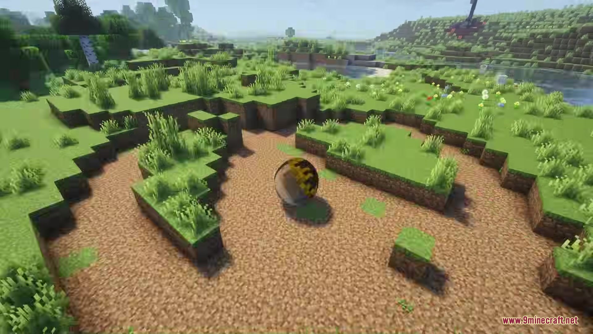 Katamari Mod Screenshot 2 A reflective sphere rolling on a dirt path to pick up nearby blocks