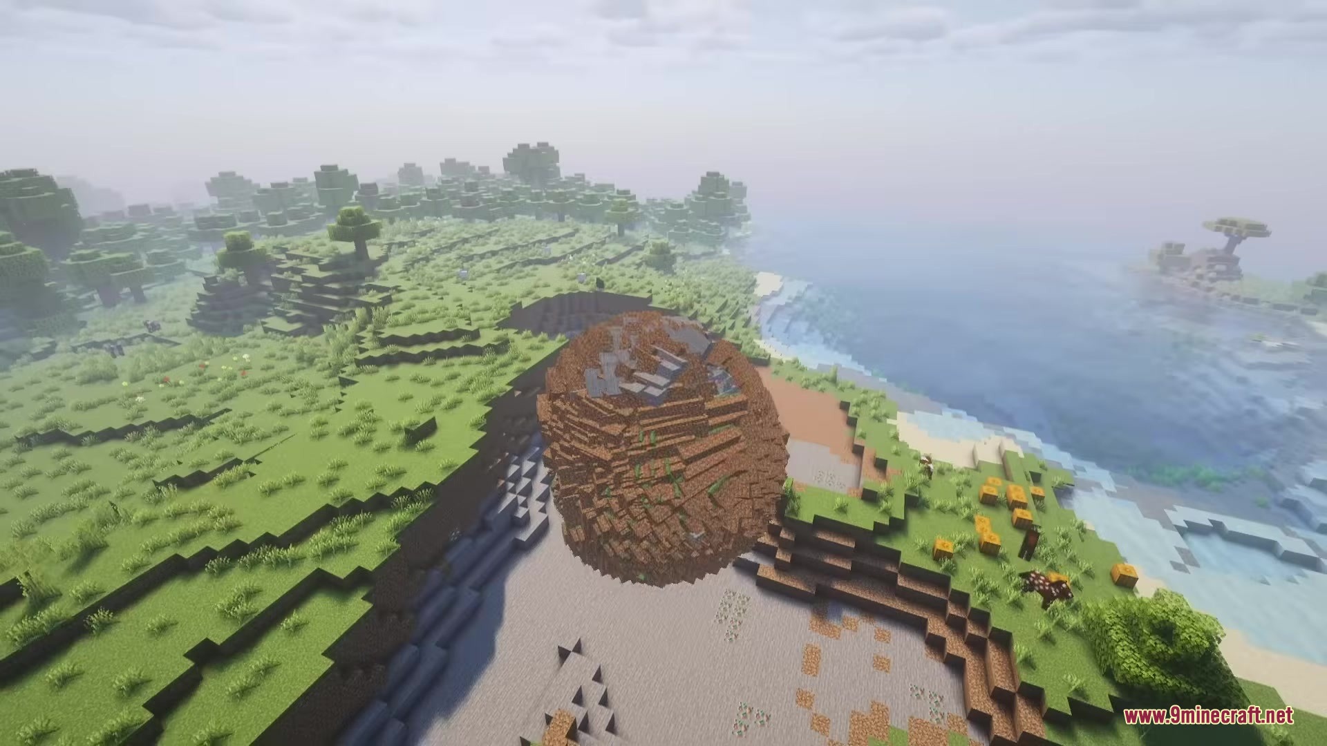 Katamari Mod Screenshot 5 A giant sphere of blocks rolling over a grassy Minecraft landscape