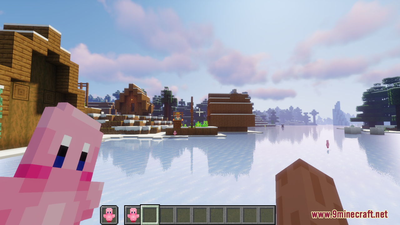 Player holding a Kirby Totem of Undying while looking at a snowy village