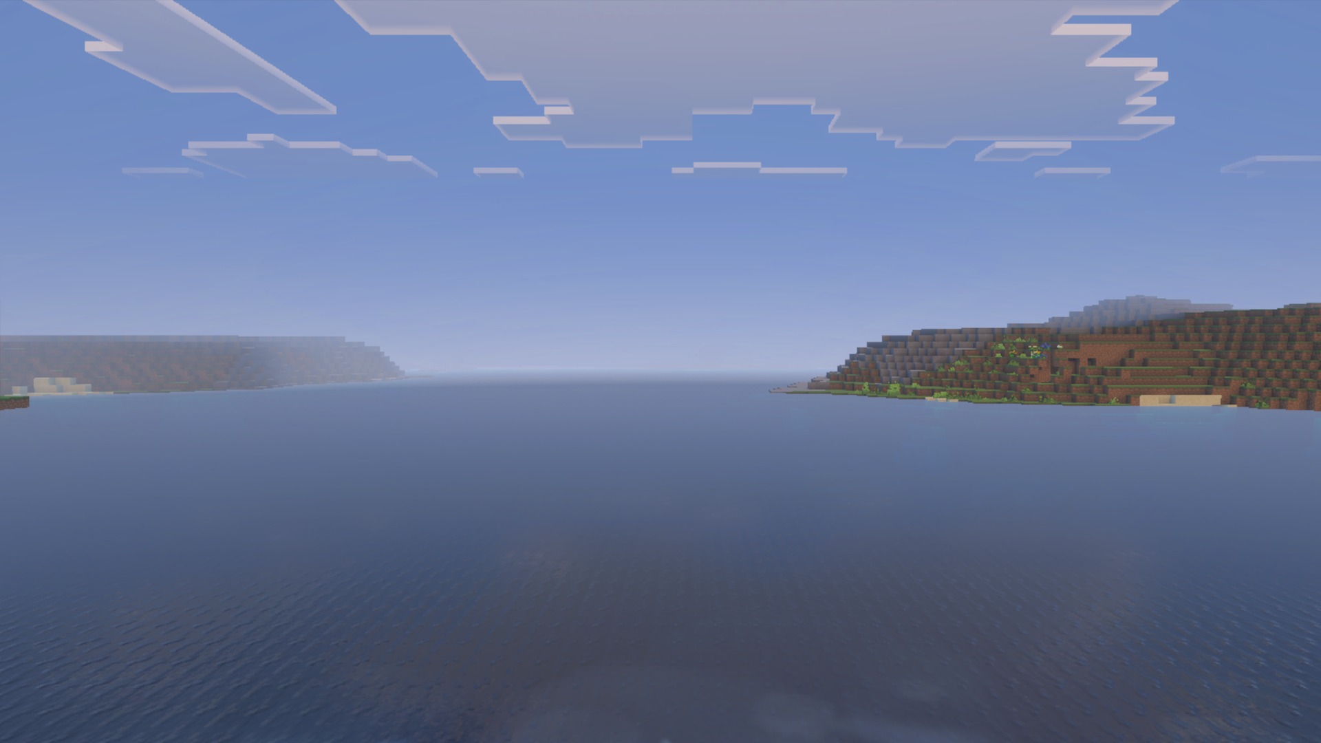 Daytime ocean water, clouds and shoreline with the La Nature pack