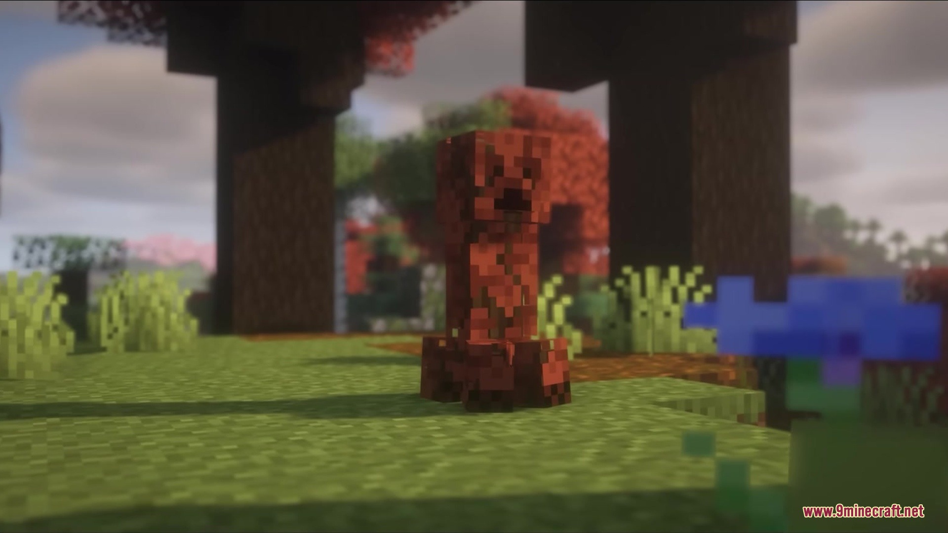 Leafy Creepers Resource Pack Screenshot 7 A red leafy creeper standing in a forest with autumn colored trees