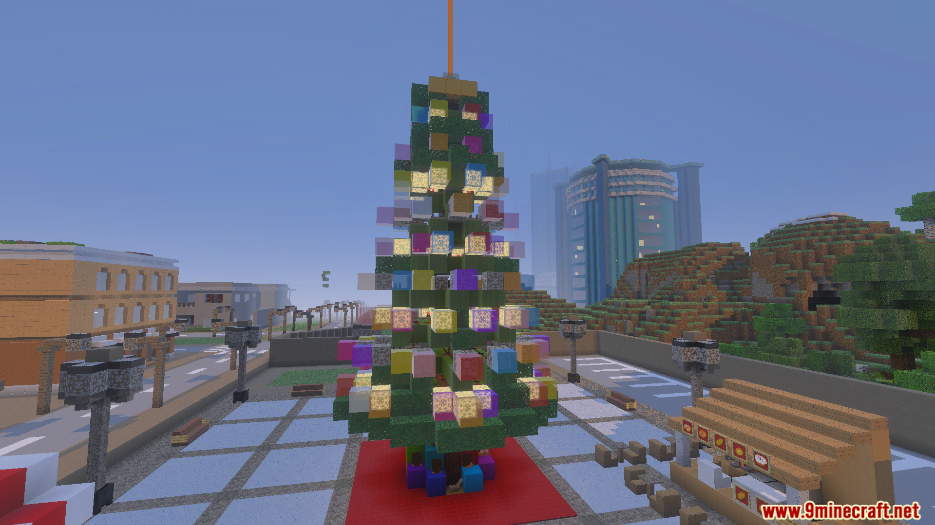 A tall Christmas tree with glowing lights and ornaments in a city