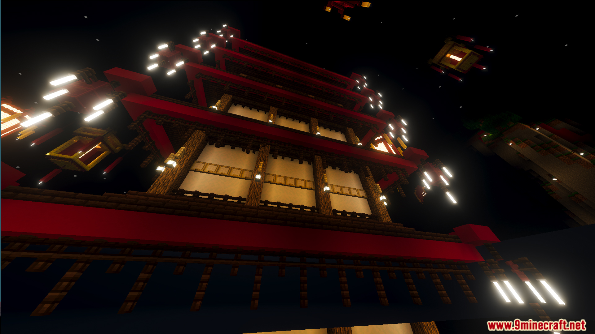 Tall red and white pagoda building illuminated against the night sky