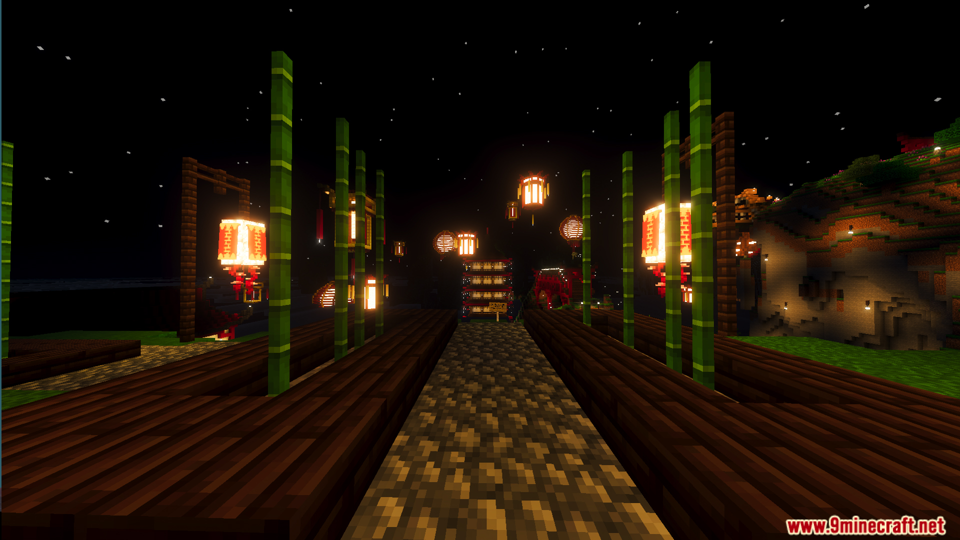 Nighttime path lined with bamboo and glowing lanterns in a festive area
