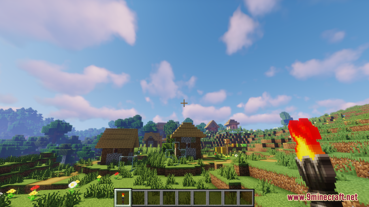 Lz Rustic Torch Resource Pack Screenshot 2 A player holds a custom rustic torch while standing in a sunny village