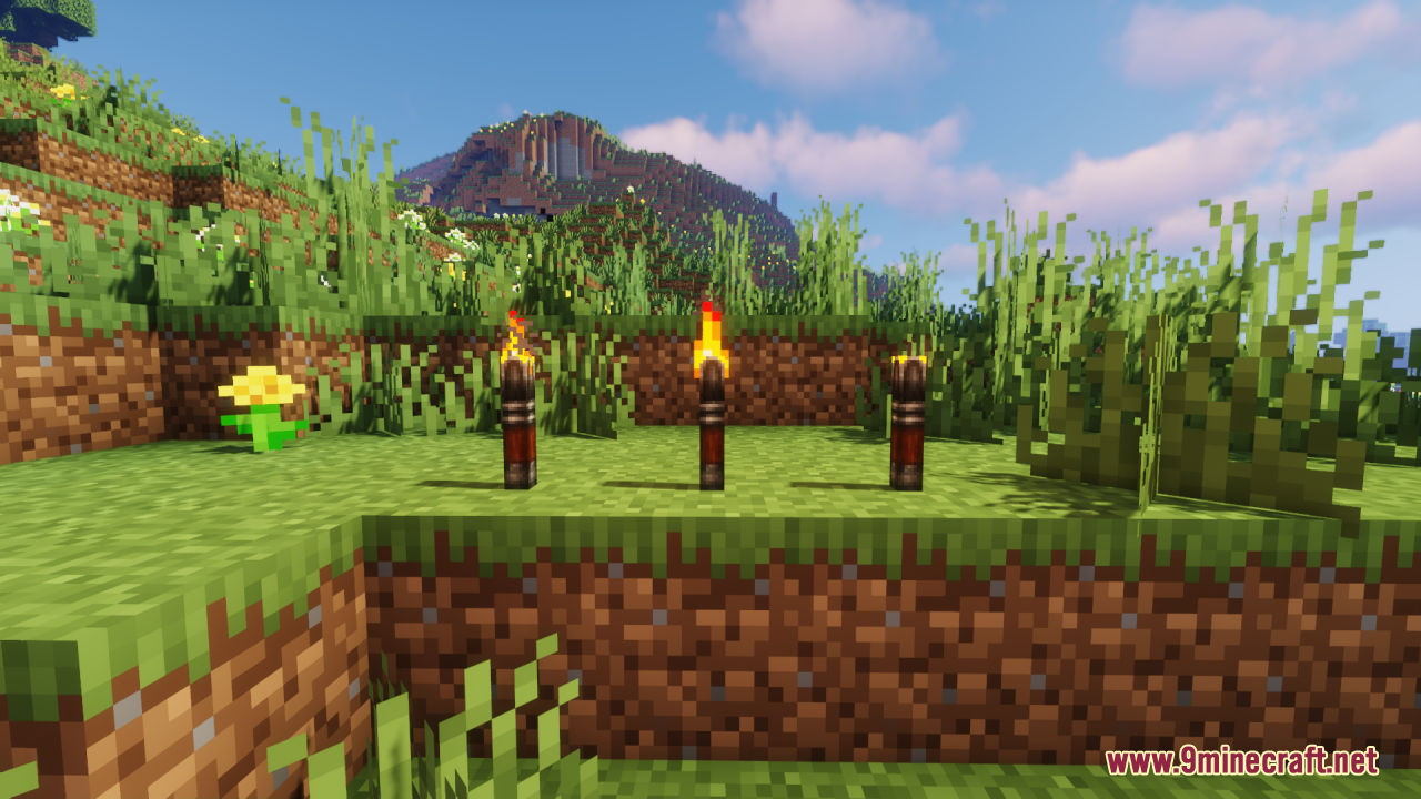 Lz Rustic Torch Resource Pack Screenshot 5 Three Lz Rustic Torches with custom models standing on grass in Minecraft