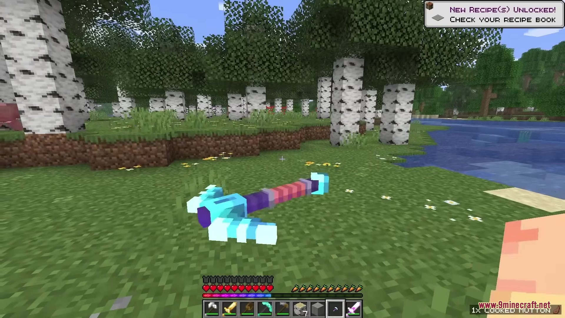 A detailed 3D pickaxe item lying on the grass in a forest