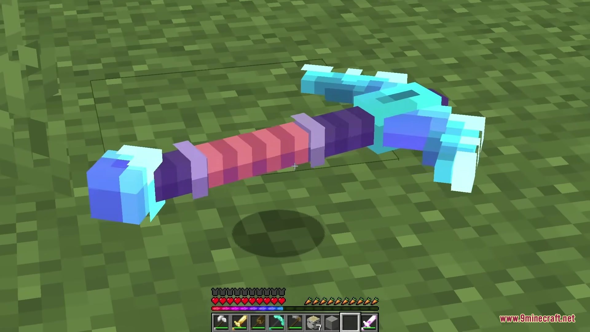 A detailed 3D diamond pickaxe model lying on the green grass block