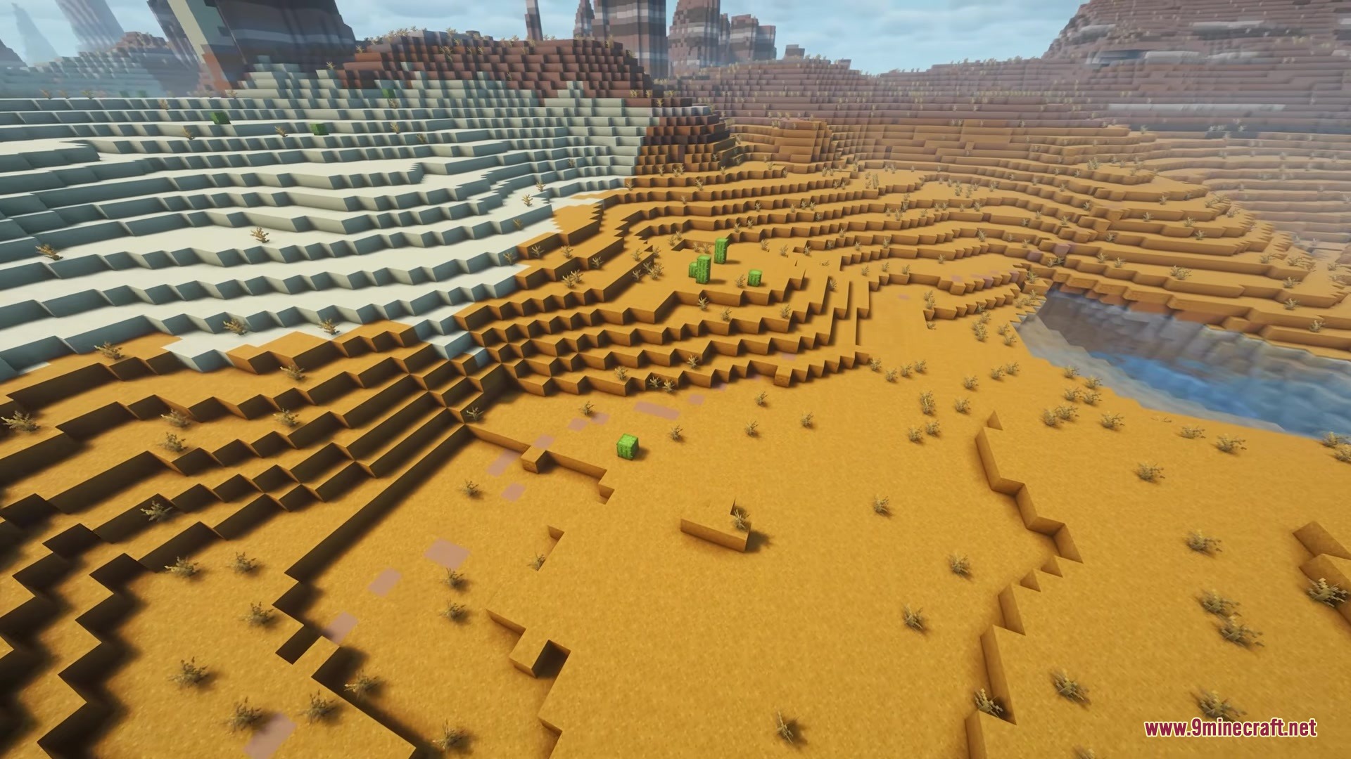 A sandstone path winds through a desert biome with hills and dead bushes
