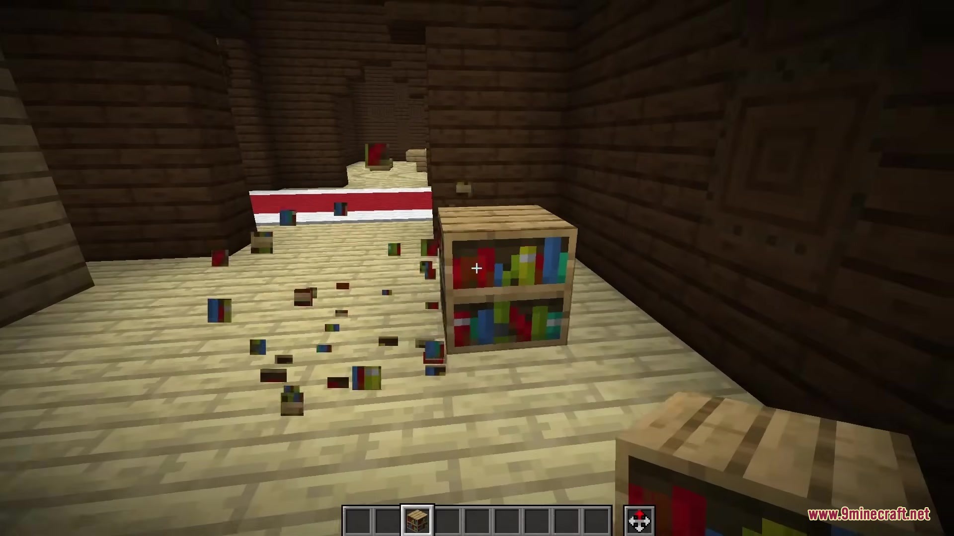 Breaking a bookshelf block creates small book particles on the wooden floor