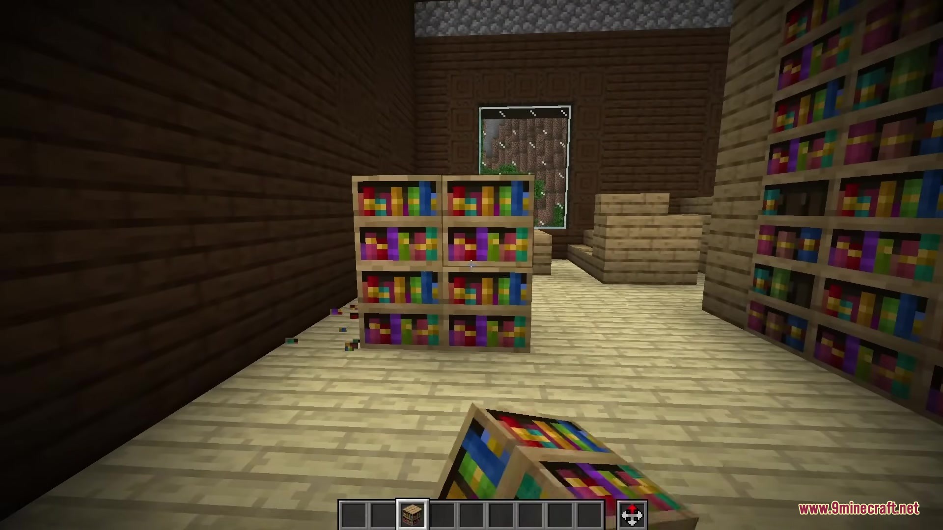 A player holds a bookshelf block while standing in a room with wooden walls