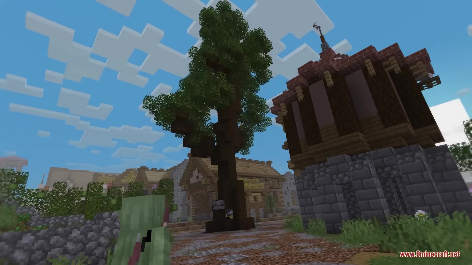 Mc Alive Leaves Resource Pack Screenshot 8 A player explores a village featuring a tall tree with moving green leaves