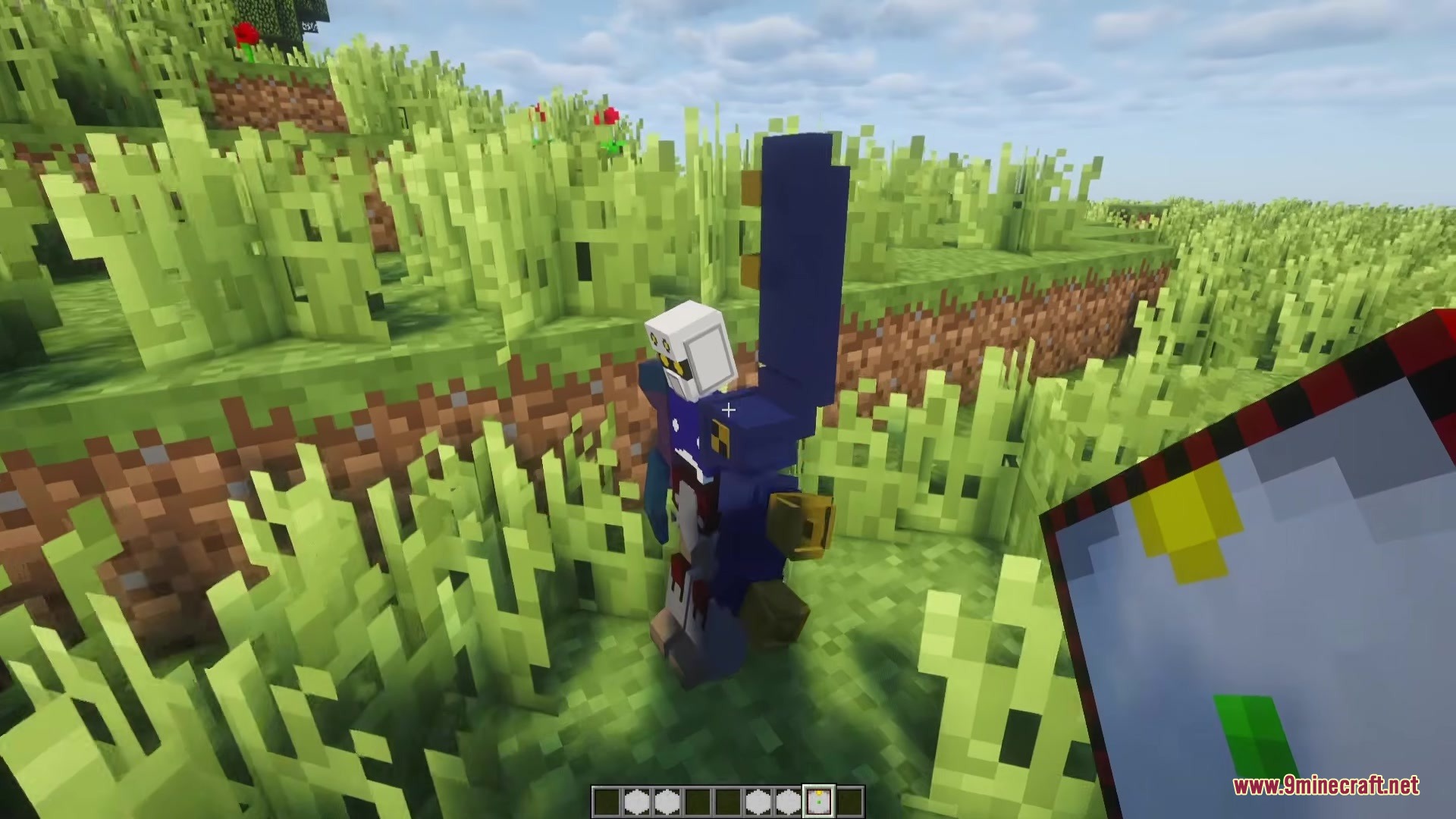 Meda Craft KD Mod Screenshot 1 A blue and white robot equipped with Medaparts stands in a grassy field