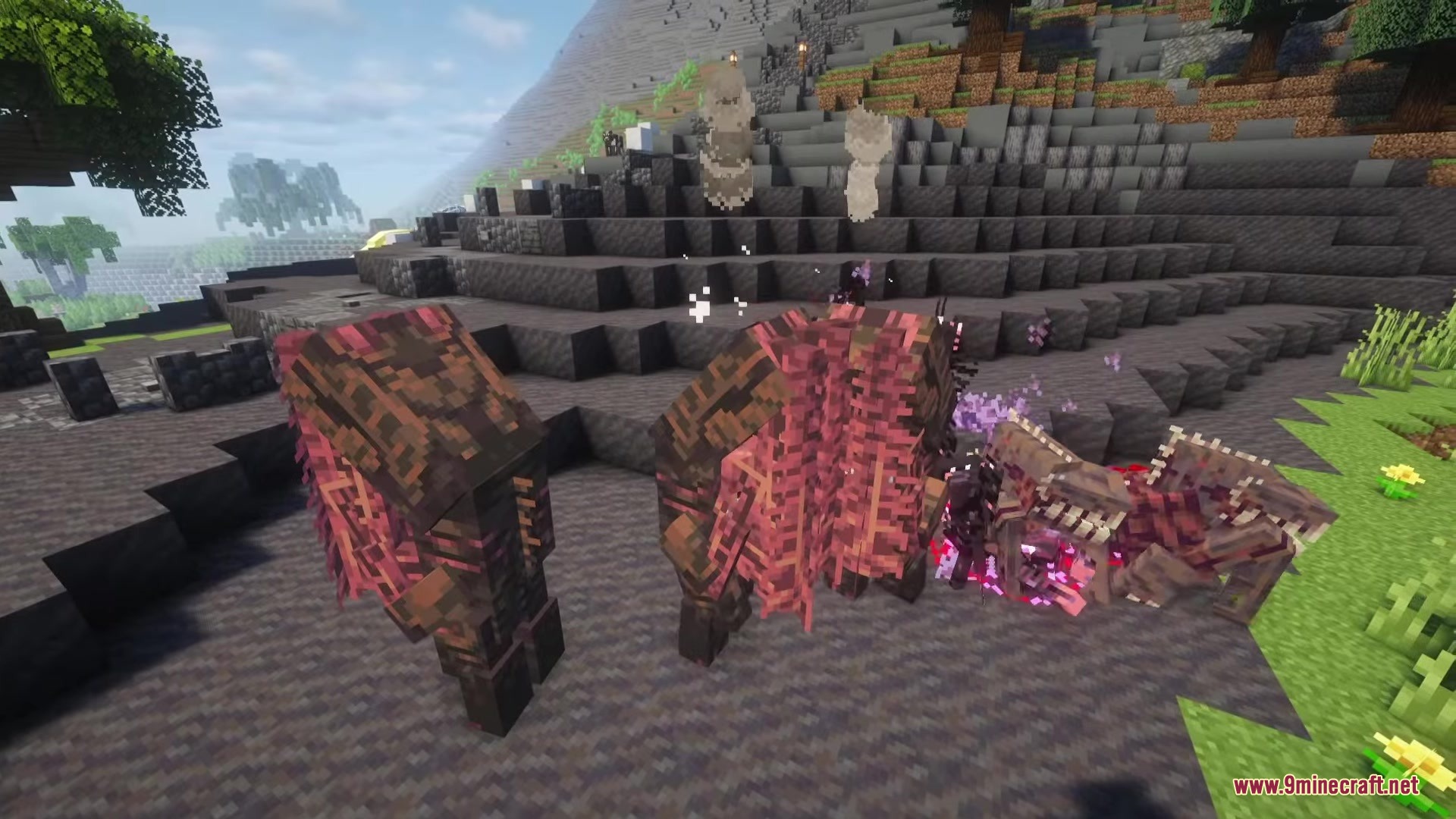 Dark hunched monsters with red textures gather on a rocky hillside