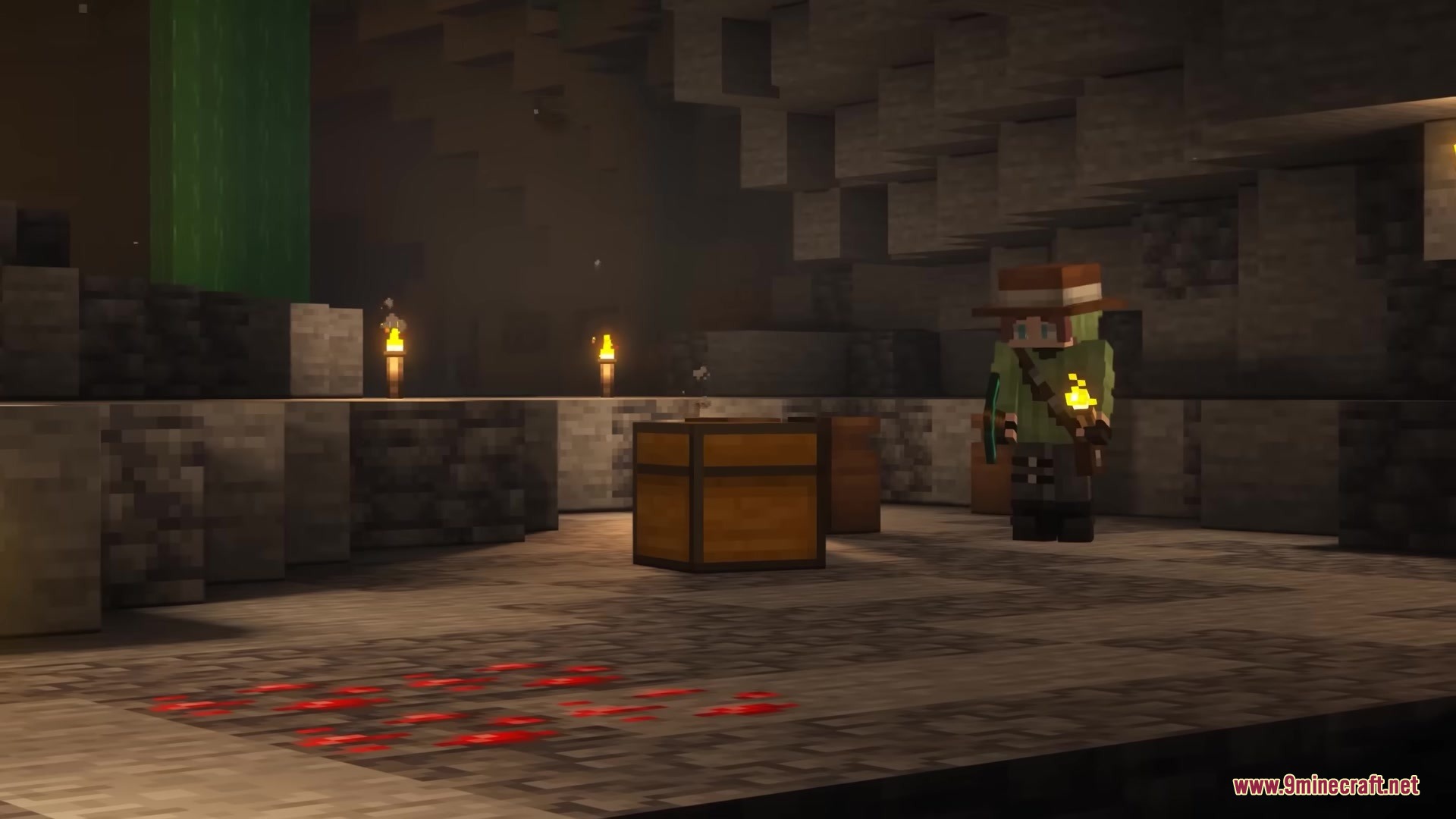 An explorer standing near a loot chest in a dark underground cave