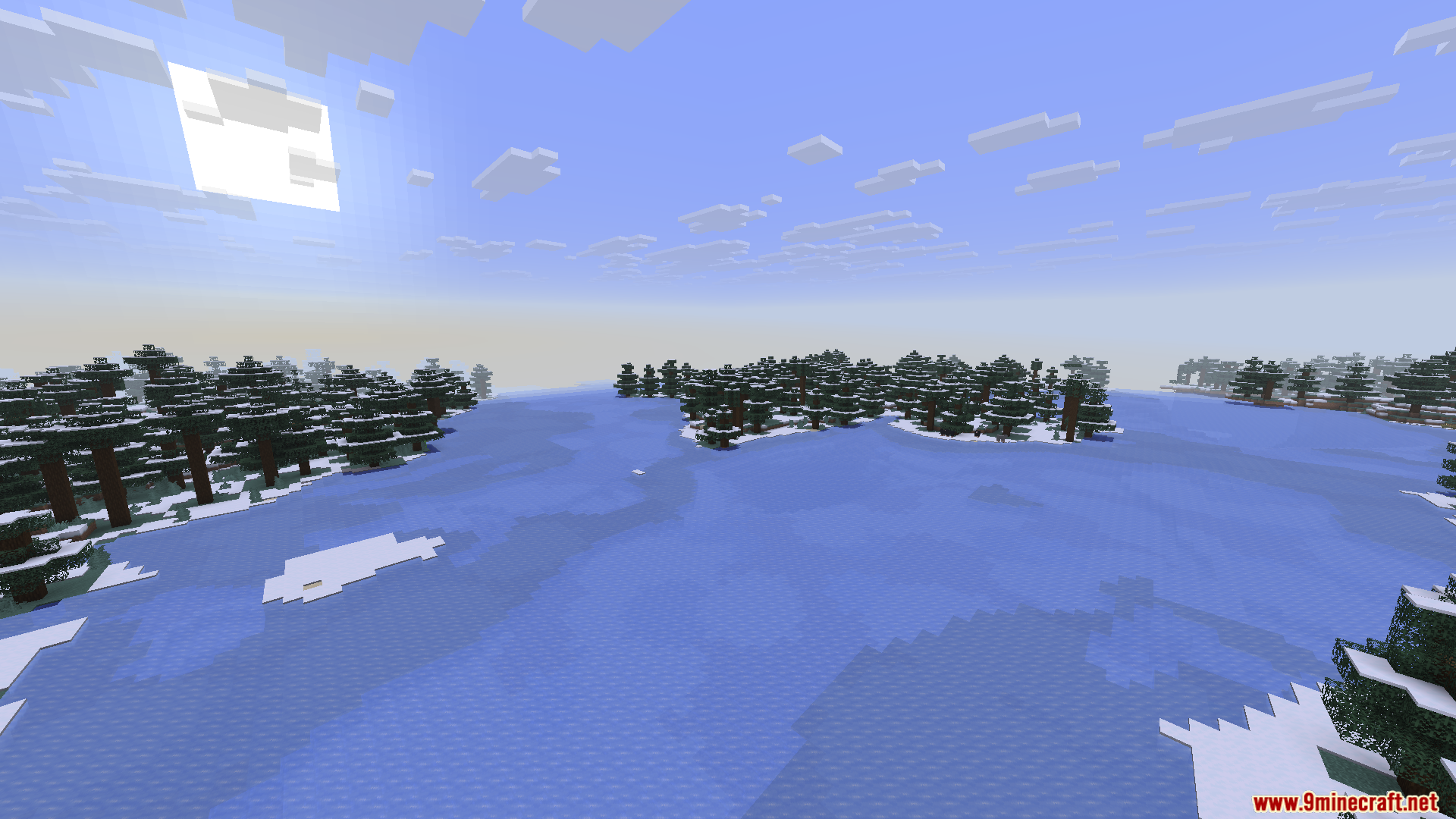 Mini Mega Mod Screenshot 6 Large frozen lake surrounded by snowy spruce trees in a taiga biome