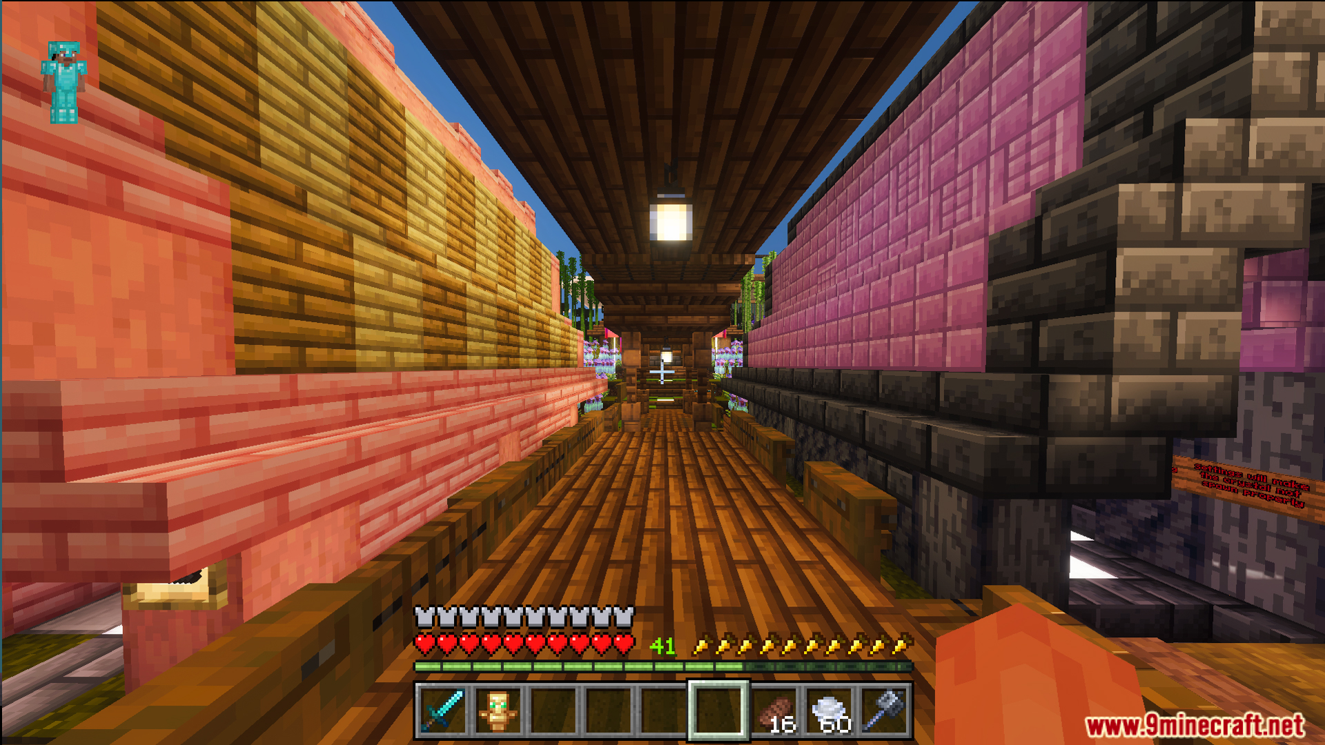 First person view of a wooden walkway between pink and orange walls