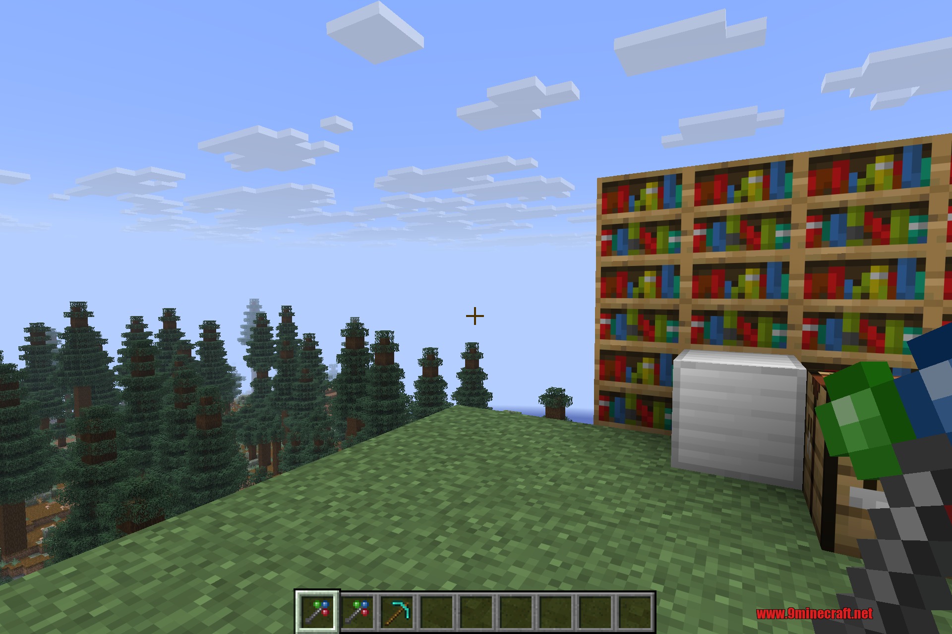Morph-o-Tool 9minecraft Mod Screenshot 1 A player holding a versatile tool near bookshelves and a crafting table