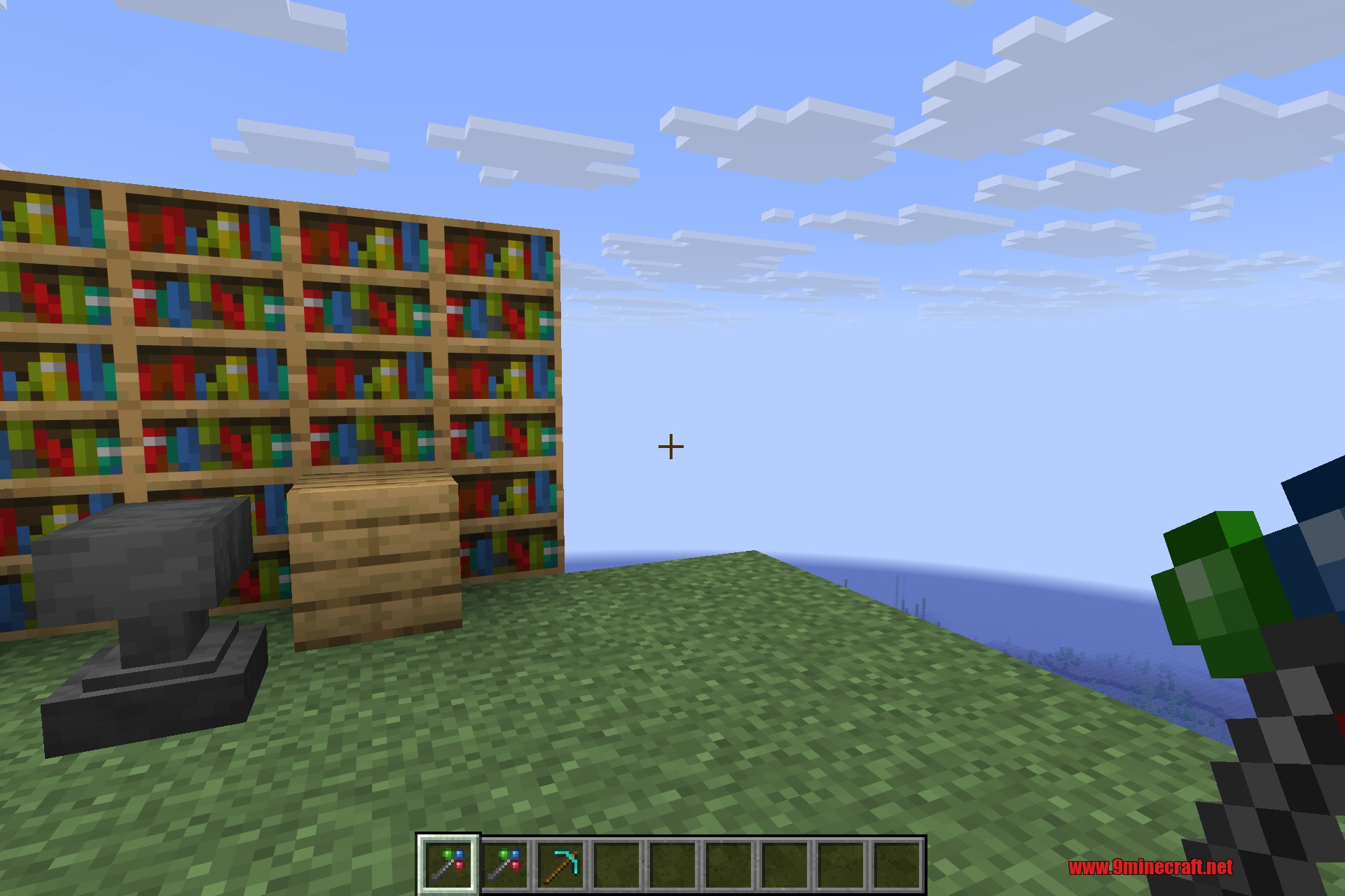 Morph-o-Tool 9minecraft Mod Screenshot 3 Player holding a multi tool while looking at an anvil and bookshelves