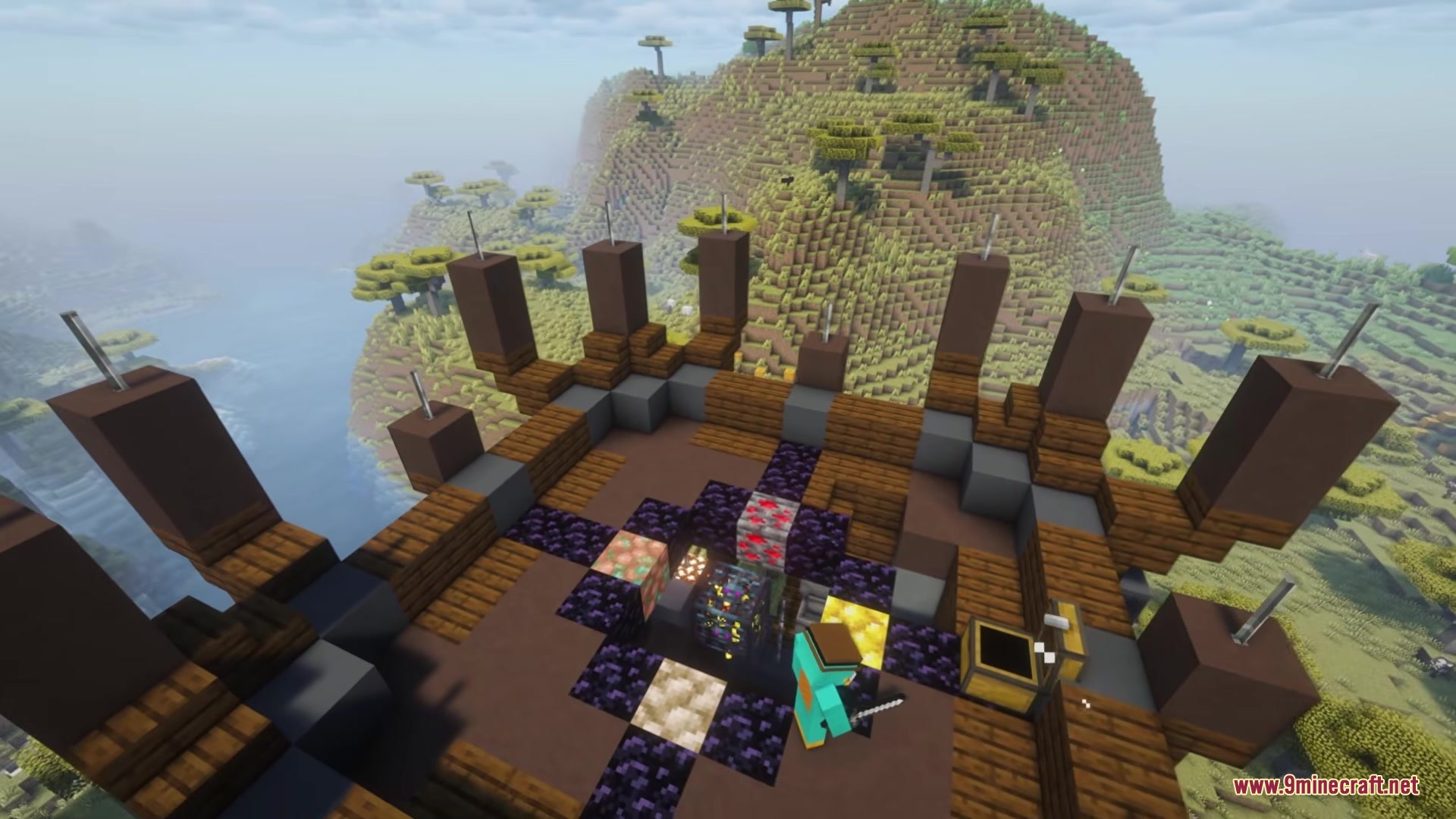 A player stands near a mob spawner and chests atop a high tower