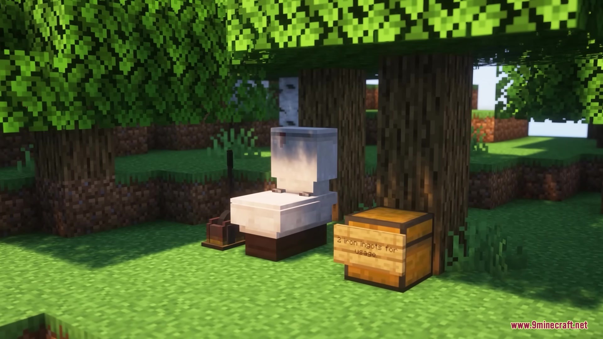 A toilet block and a chest with a sign under a tree