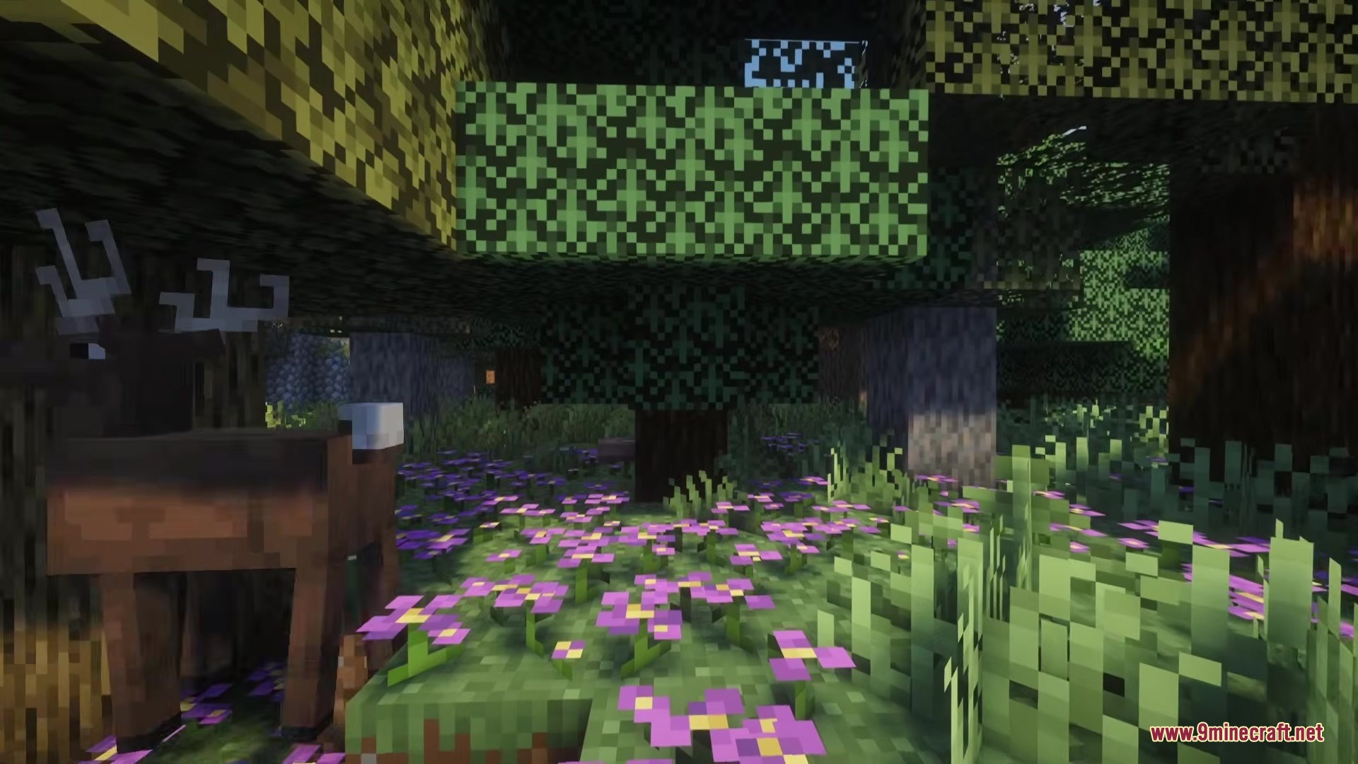 No Mans Land Mod Screenshot 1 A deer stands among purple flowers in a lush green forest biome