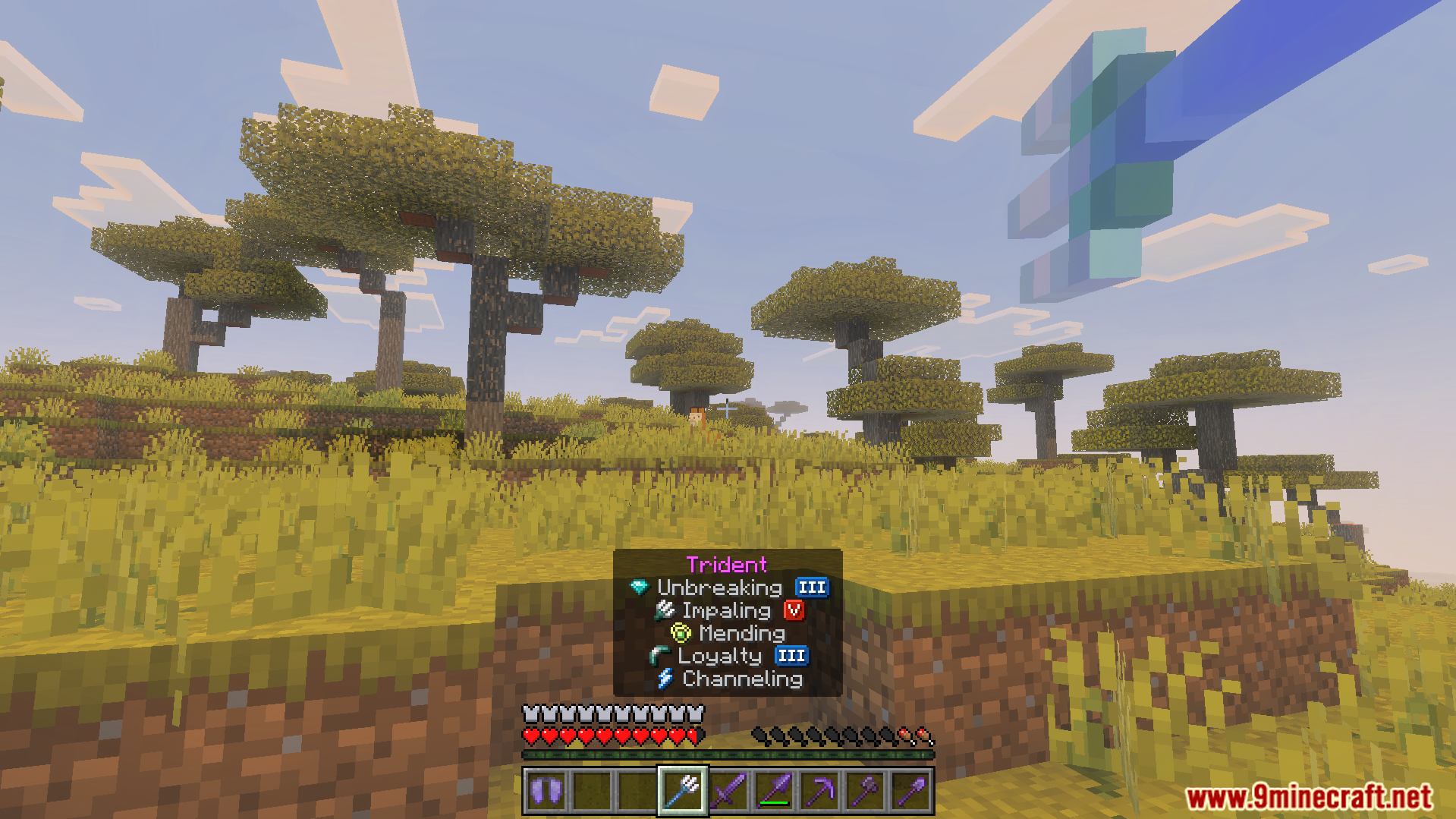 Player holding an enchanted trident with powerful enchantments in a savanna biome