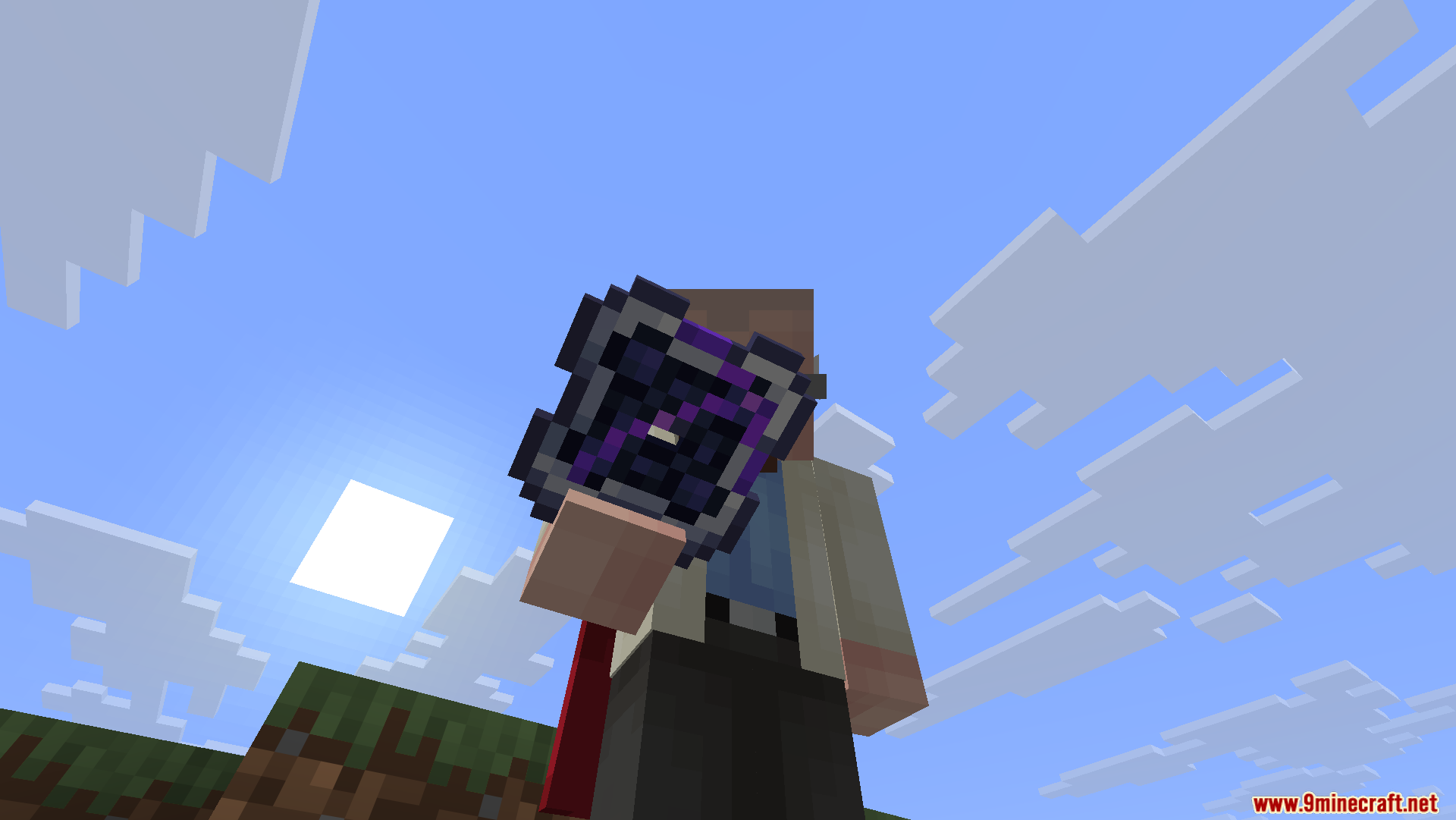 A player holding a purple Omni Storage Cell against the bright blue sky