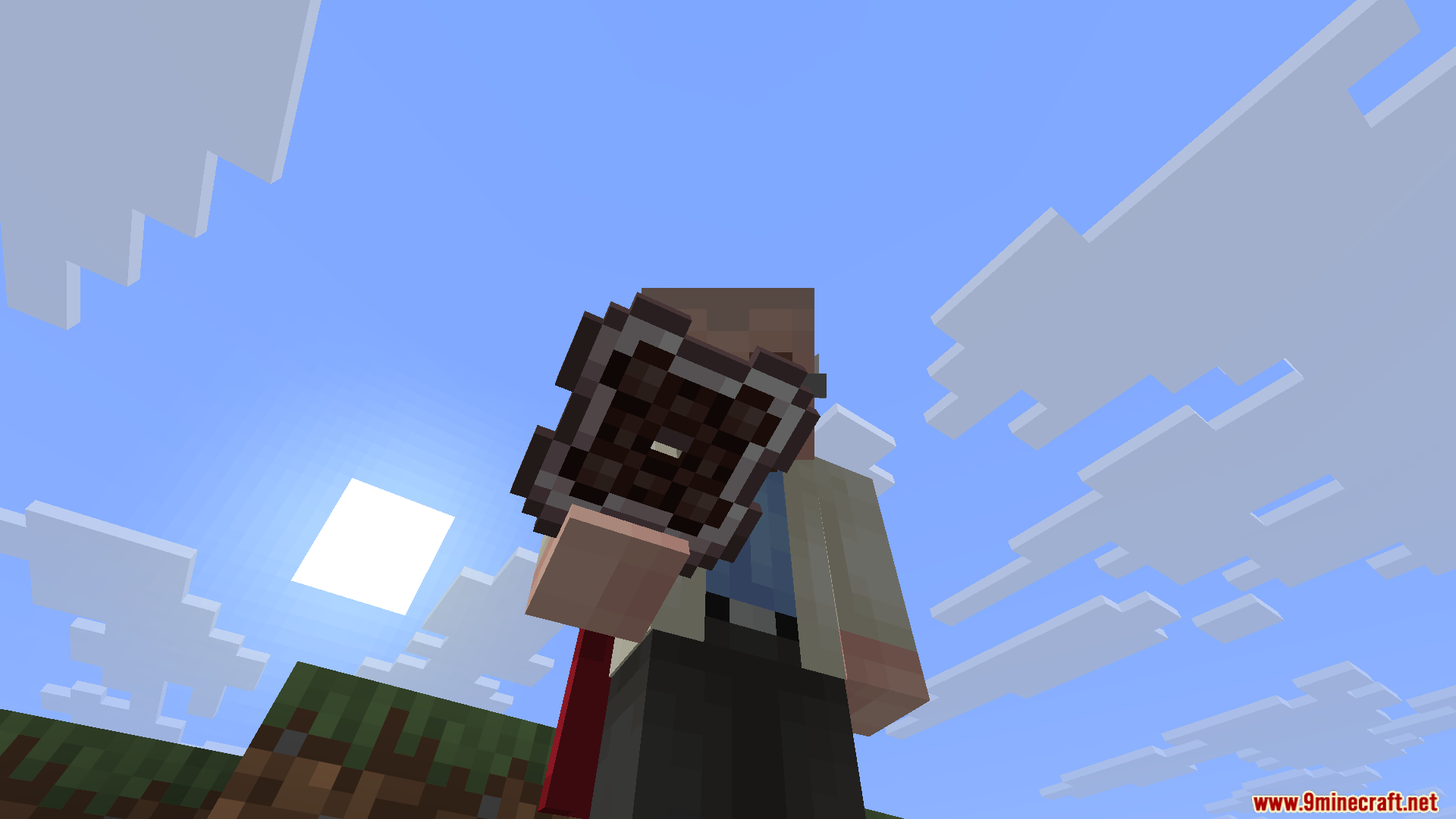 A player holding a brown storage cell item against the bright blue sky