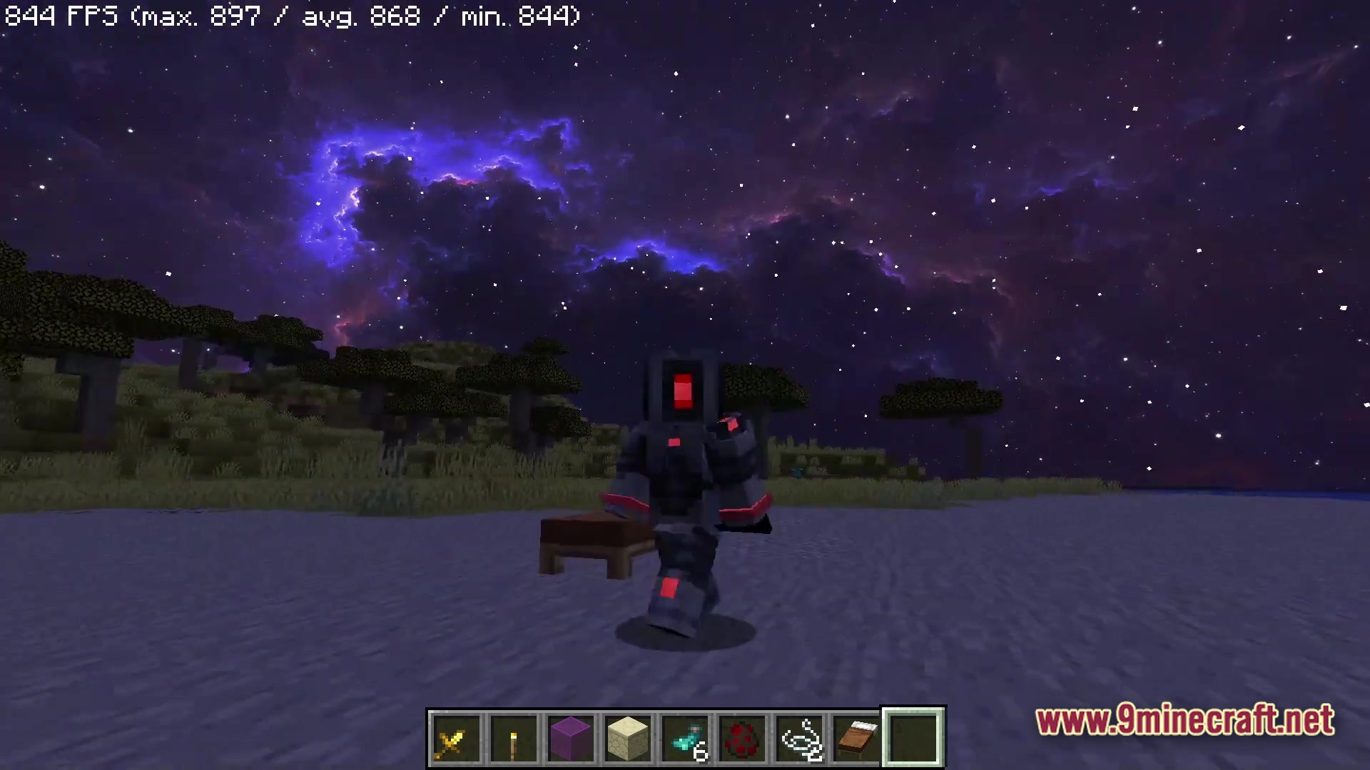 A player in custom armor stands under a purple nebula sky in a savanna biome