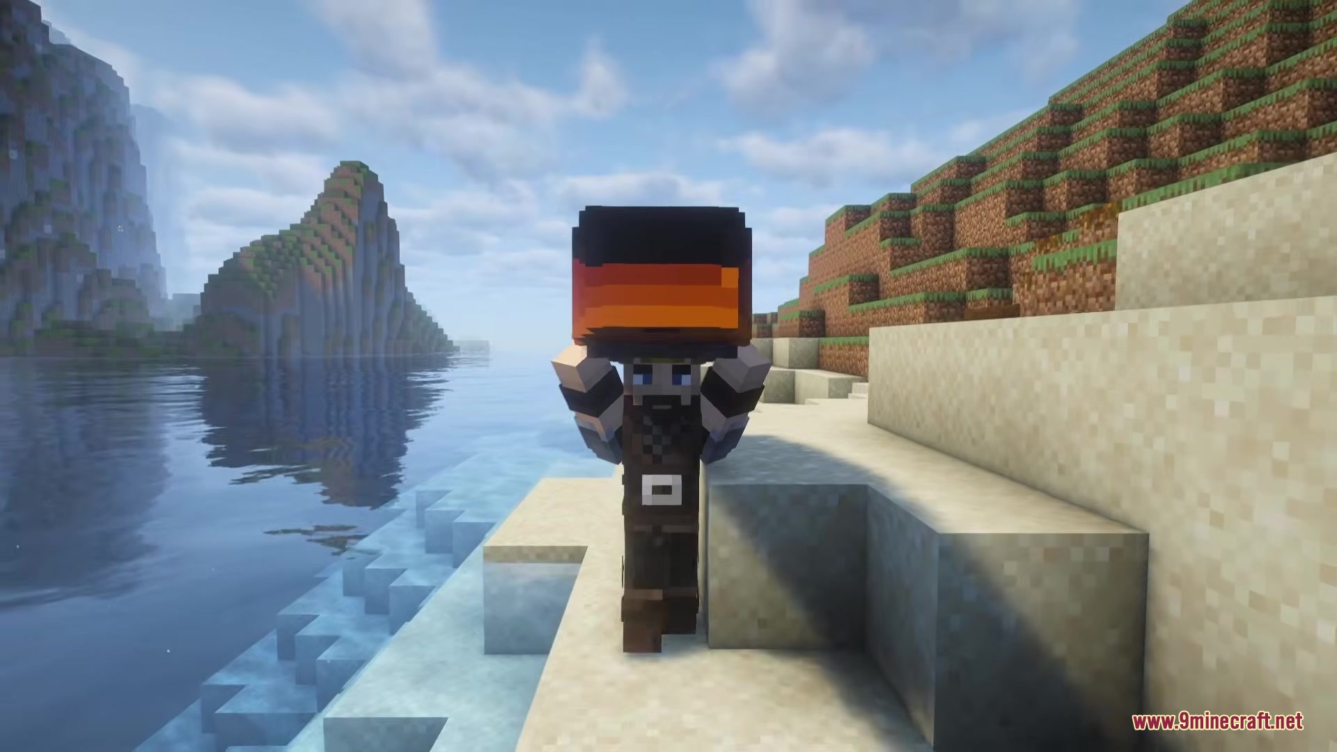 A player carries an Outback Kayak on their back while walking along the beach