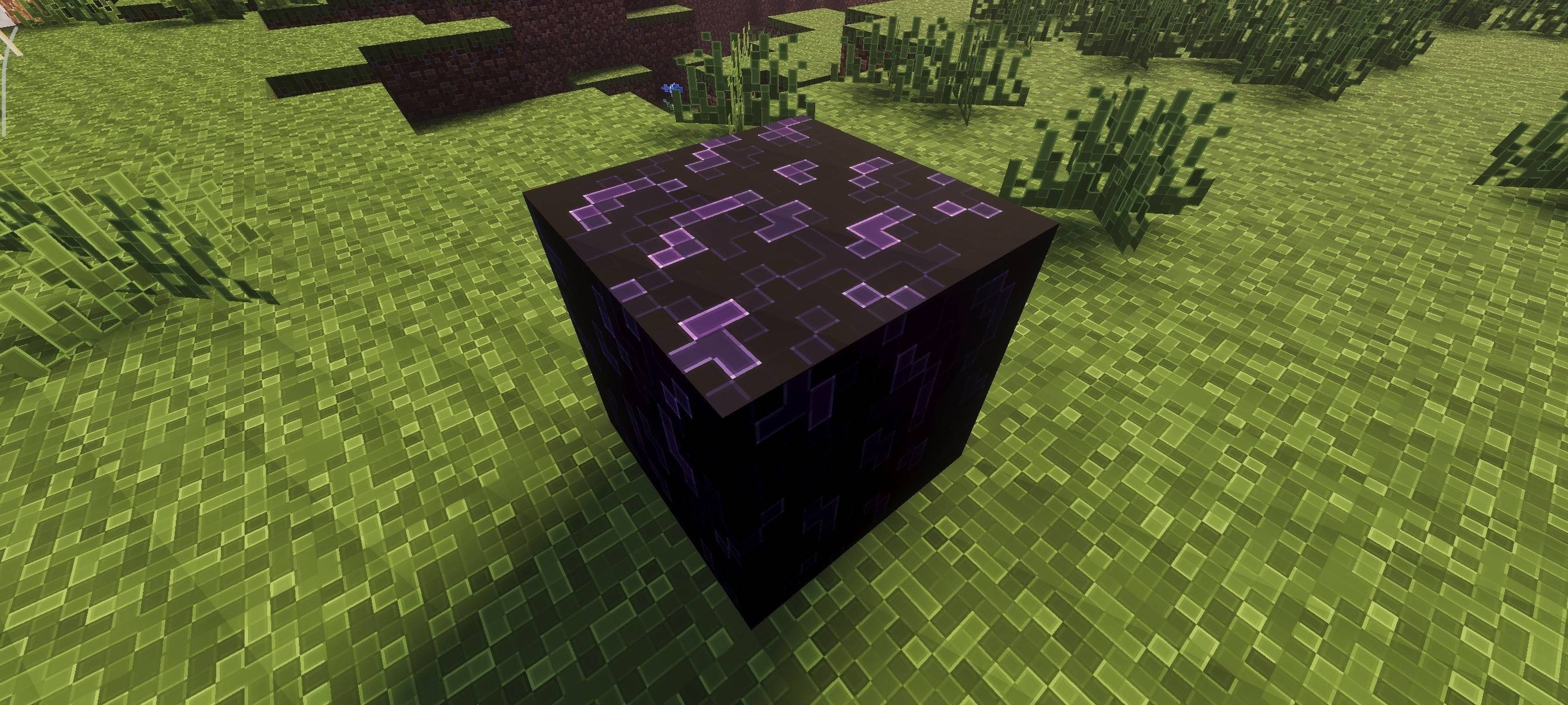 High resolution crying obsidian block with sharp outlines placed on green grass