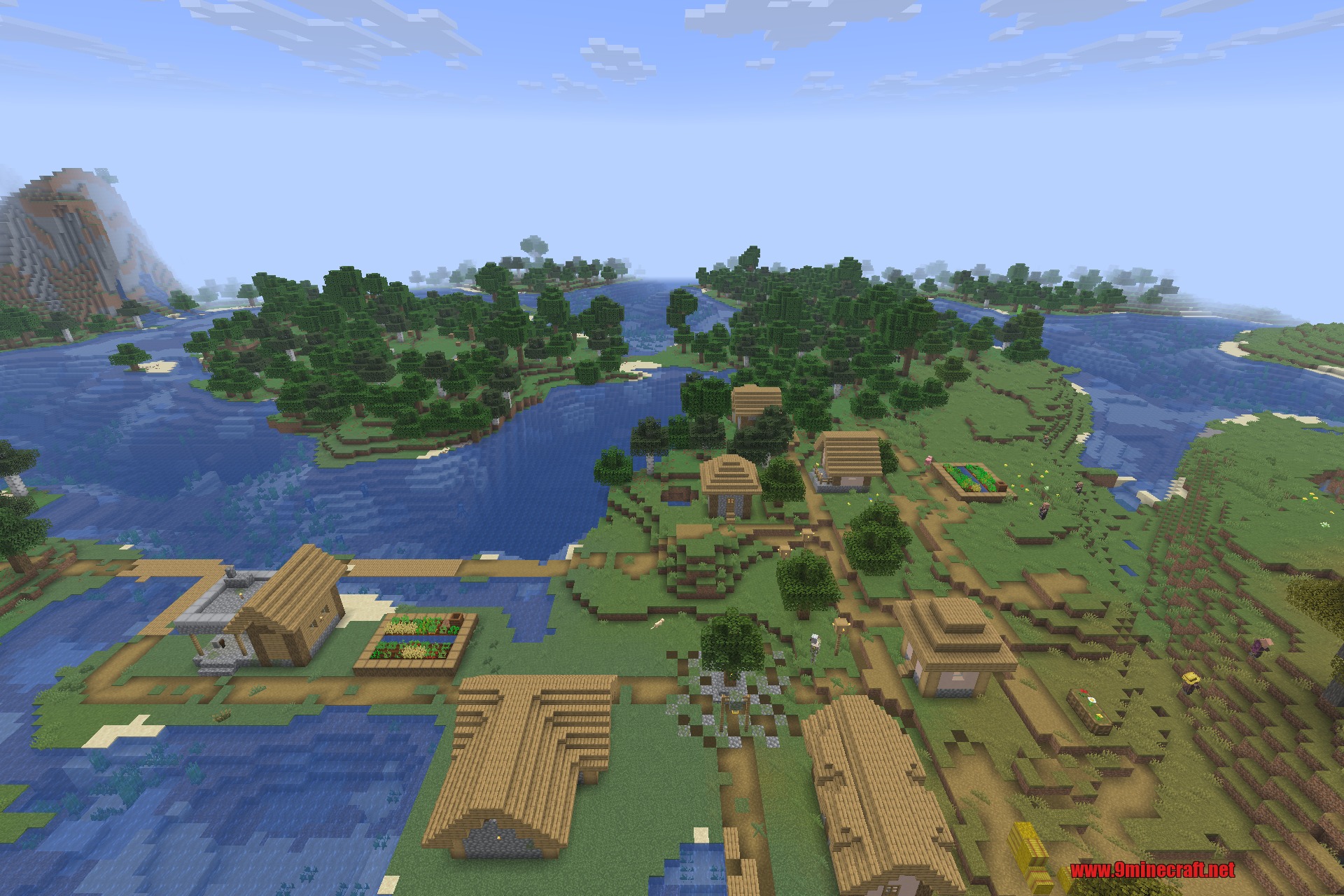 Overhauled Village 9minecraft Mod Screenshot 2 A large village with wooden houses situated next to a blue river