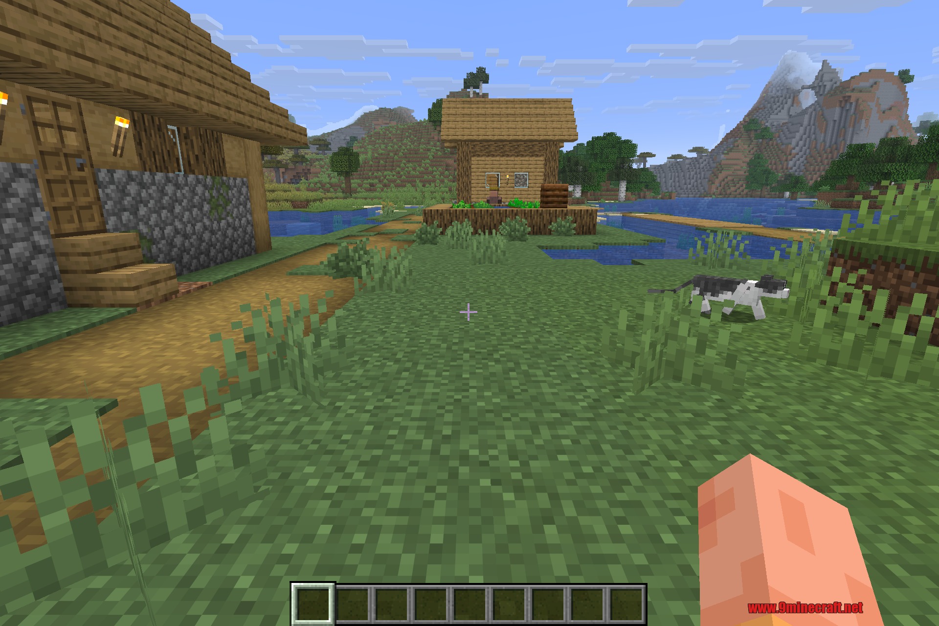 Overhauled Village 9minecraft Mod Screenshot 3 A player explores a plains village with a black and white cat on grass