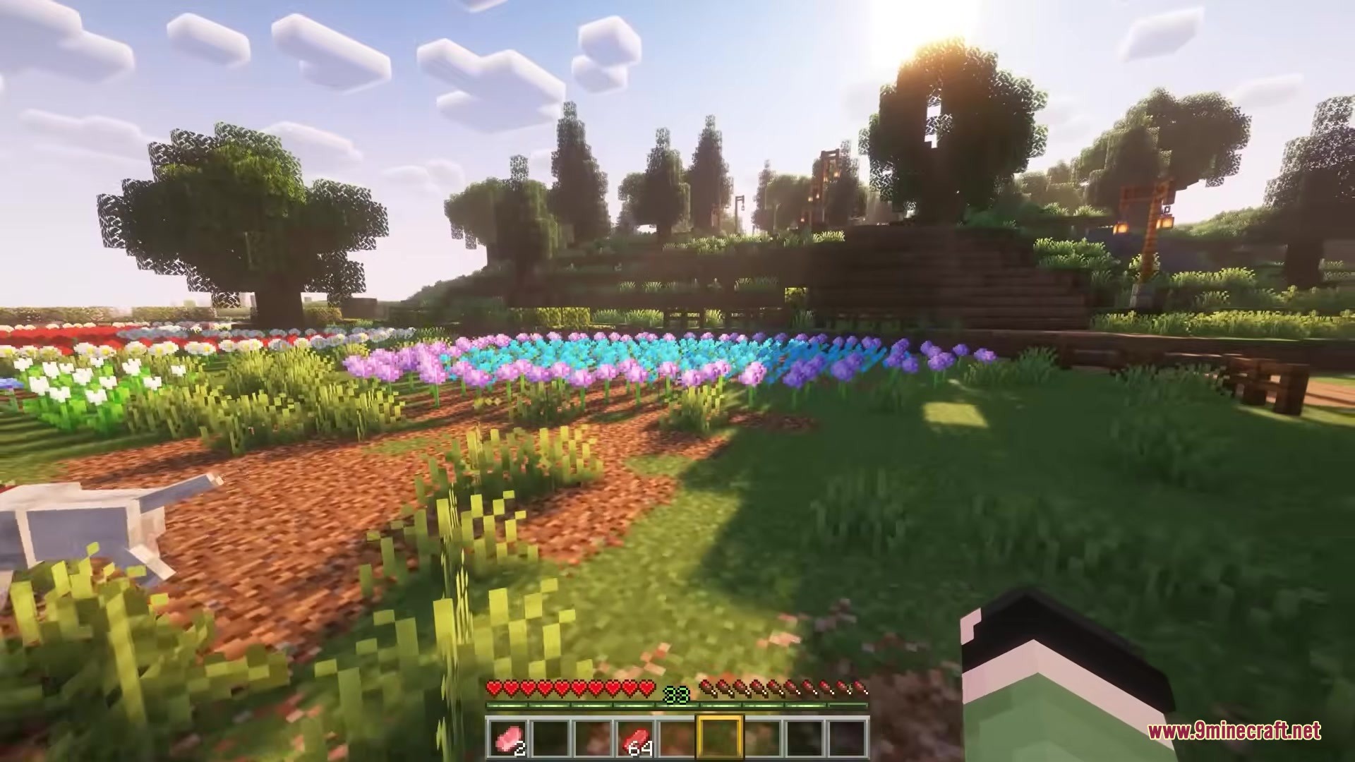Sunlight shines through trees onto a colorful field of Minecraft flowers