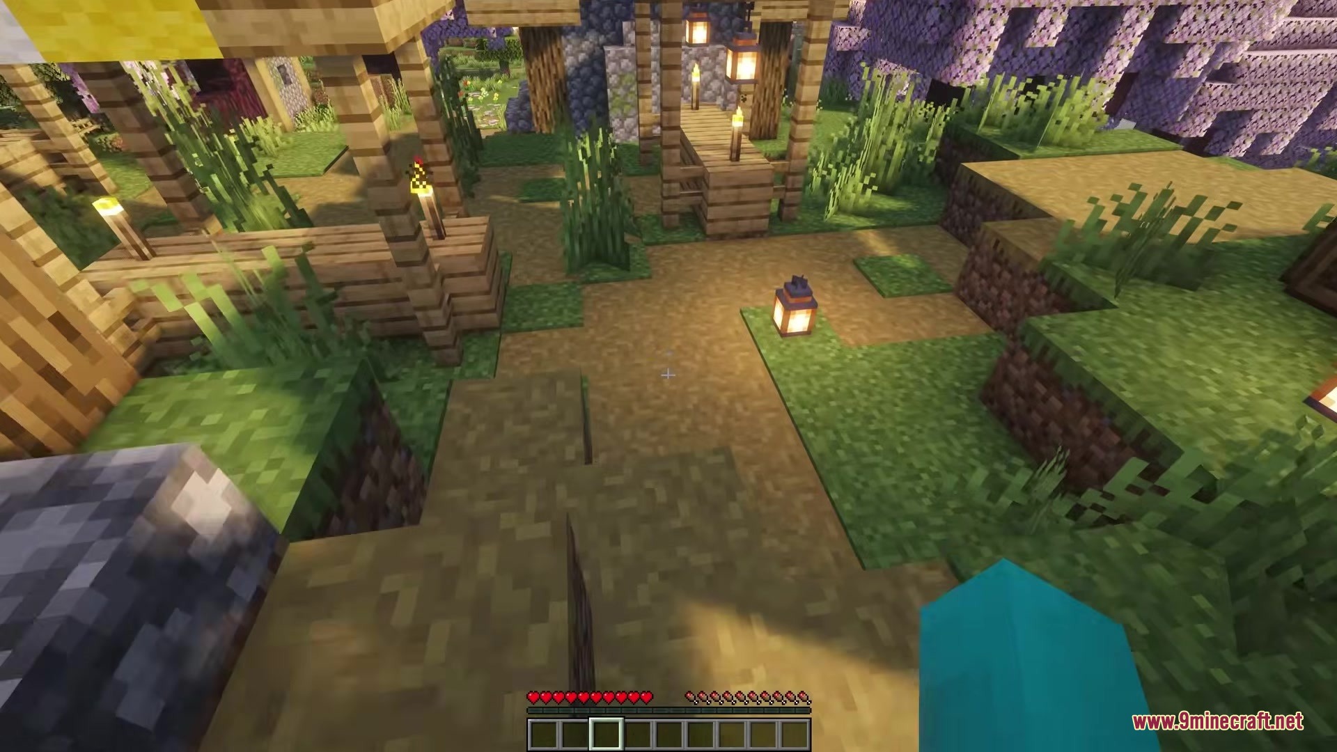 Picker Upper Mod Screenshot 2 A village path with lanterns and torches placed on the grassy ground