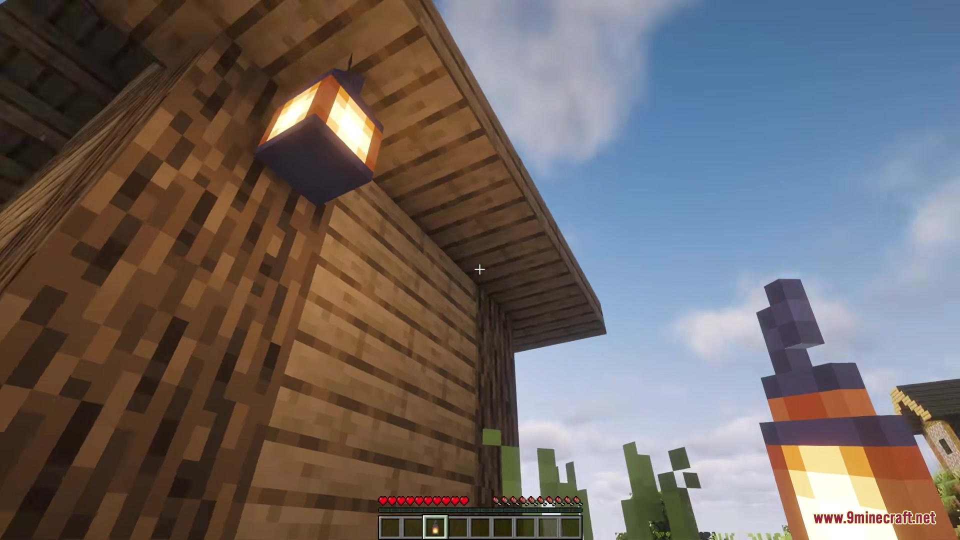 Picker Upper Mod Screenshot 4 Player looking up at a lantern hanging from the roof of a house