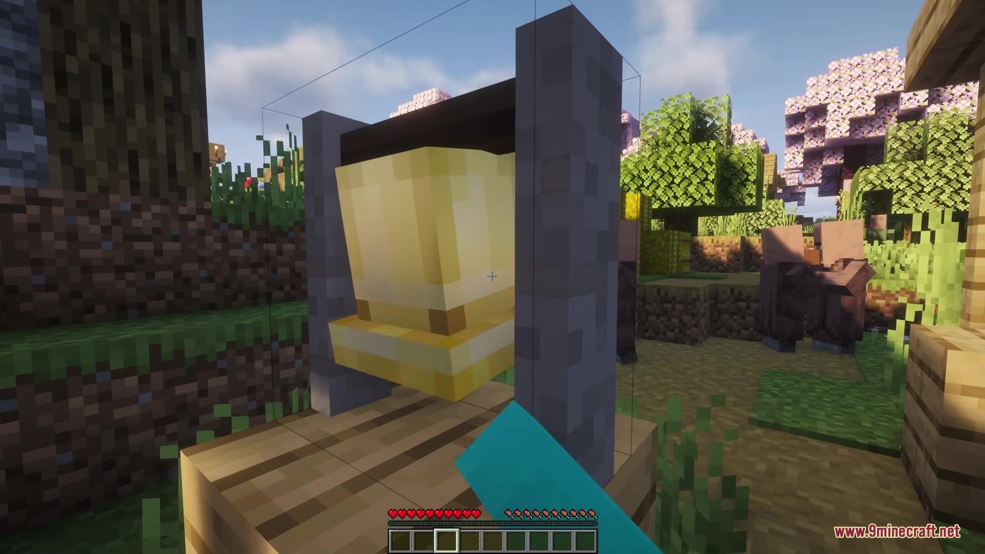 Picker Upper Mod Screenshot 8 A close up view of a golden bell structure in a village