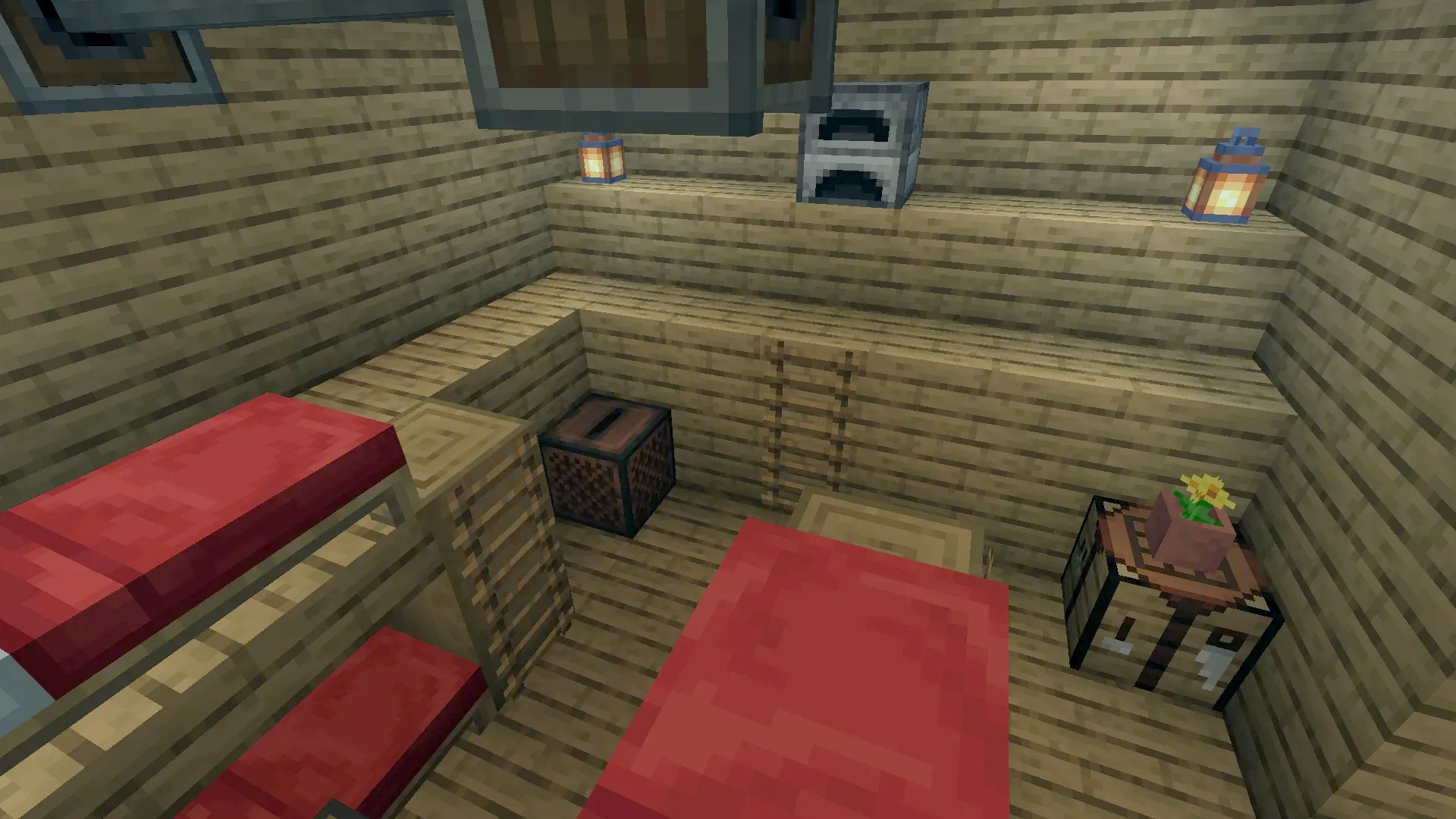 Interior of a wooden crew bedroom featuring red bunk beds and a jukebox